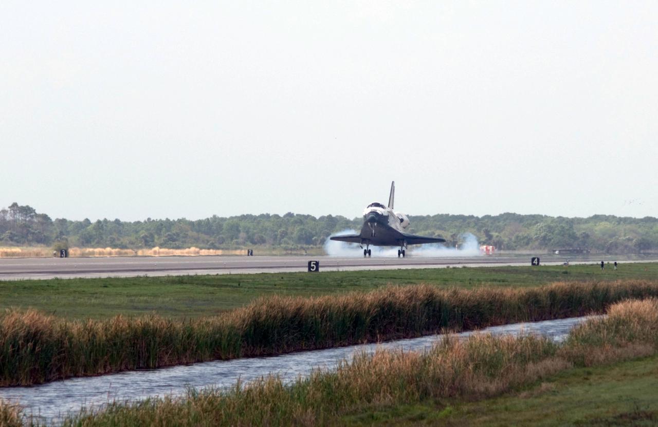 STS119-S-055 (28 March 2009) --- Space Shuttle Discovery touches down on Runway 15 of the Shuttle Landing Facility at NASA's Kennedy Space Center, concluding the 13-day, 5.3-million mile journey of the STS-119 mission to the International Space Station. Onboard are NASA astronauts Lee Archambault, commander; Tony Antonelli, pilot; Steve Swanson, Richard Arnold, Joseph Acaba, John Phillips and Sandra Magnus, all mission specialists. The main landing gear touched down at 3:13:17 p.m. (EDT) on March 28, 2009. The nose gear touched down at 3:13:40 p.m. and wheels stop was at 3:14:45 p.m. During the mission, Discovery?s crew delivered and installed the final pair of large power-generating solar array wings and the S6 truss segment to the starboard, or right, side of the station and accomplished important tasks to prepare the station for future upgrades and additions later this year.