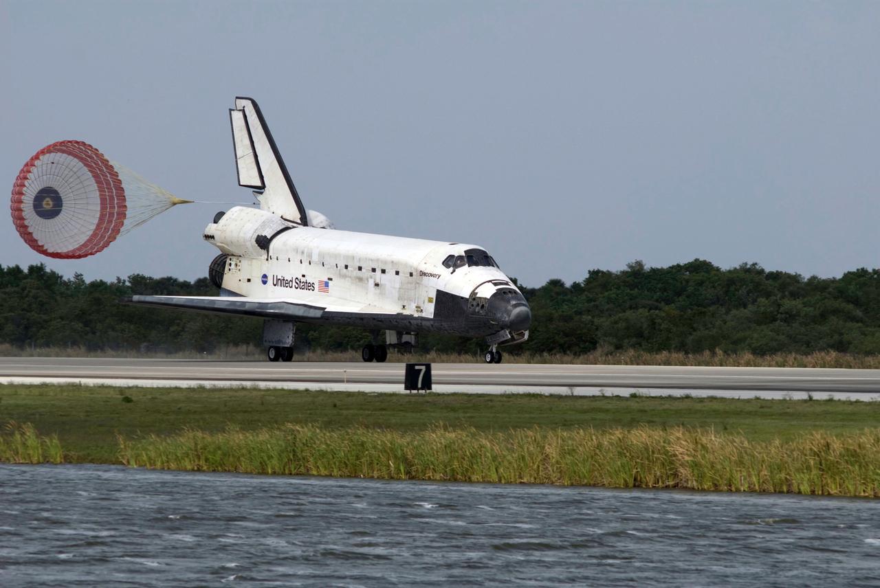 STS119-S-061 (28 March 2009) --- Space Shuttle Discovery?s drag chute is deployed as the spacecraft rolls toward wheels stop on Runway 15 of the Shuttle Landing Facility at NASA's Kennedy Space Center, concluding the 13-day, 5.3-million mile journey of the STS-119 mission to the International Space Station. Onboard are NASA astronauts Lee Archambault, commander; Tony Antonelli, pilot; Steve Swanson, Richard Arnold, Joseph Acaba, John Phillips and Sandra Magnus, all mission specialists. The main landing gear touched down at 3:13:17 p.m. (EDT) on March 28, 2009. The nose gear touched down at 3:13:40 p.m. and wheels stop was at 3:14:45 p.m. During the mission, Discovery?s crew delivered and installed the final pair of large power-generating solar array wings and the S6 truss segment to the starboard, or right, side of the station and accomplished important tasks to prepare the station for future upgrades and additions later this year.
