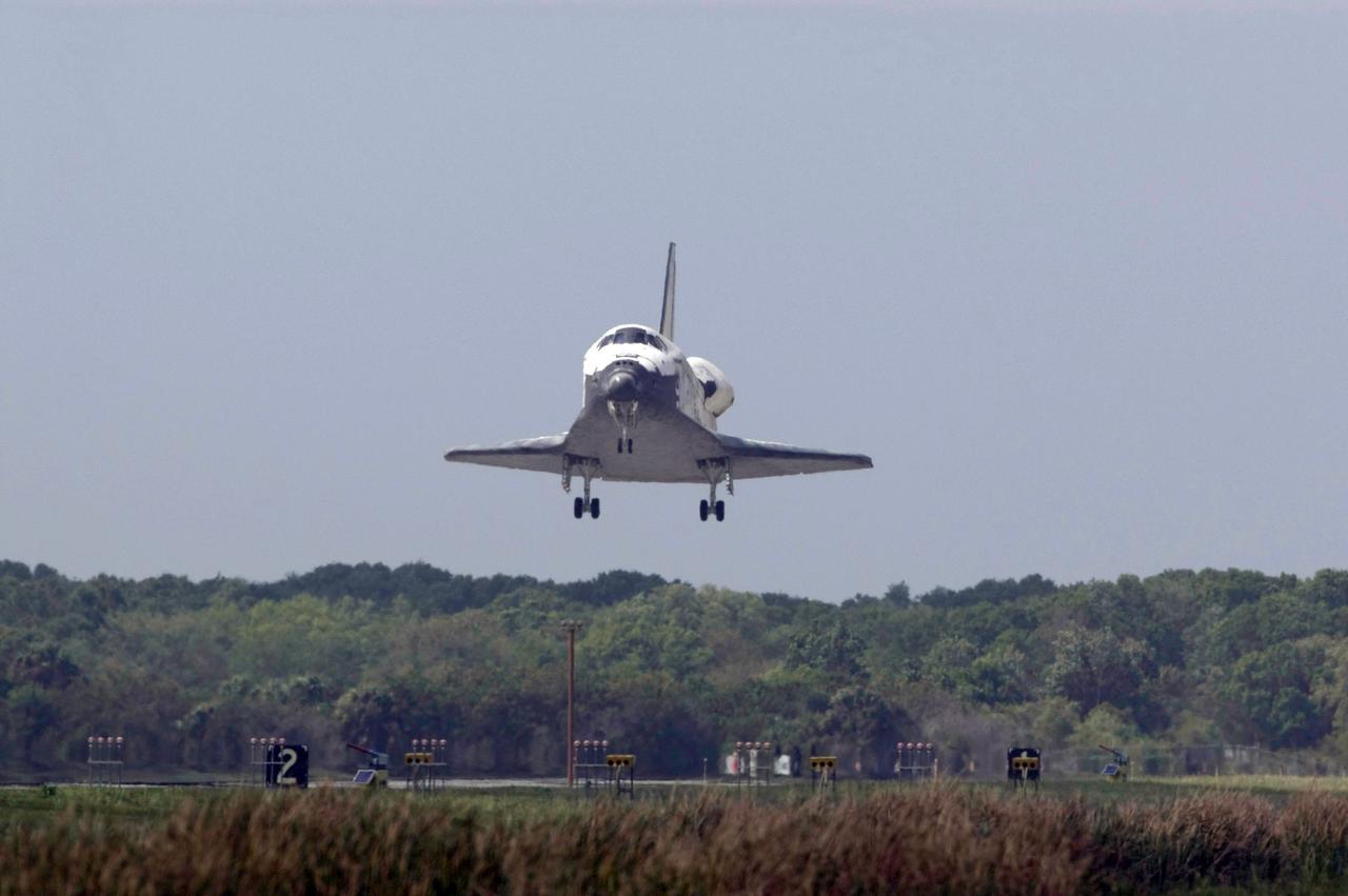 STS119-S-064 (28 March 2009) --- Space Shuttle Discovery approaches landing on Runway 15 of the Shuttle Landing Facility at NASA's Kennedy Space Center, concluding the 13-day, 5.3-million mile journey of the STS-119 mission to the International Space Station. Onboard are NASA astronauts Lee Archambault, commander; Tony Antonelli, pilot; Steve Swanson, Richard Arnold, Joseph Acaba, John Phillips and Sandra Magnus, all mission specialists. The main landing gear touched down at 3:13:17 p.m. (EDT) on March 28, 2009. The nose gear touched down at 3:13:40 p.m. and wheels stop was at 3:14:45 p.m. During the mission, Discovery?s crew delivered and installed the final pair of large power-generating solar array wings and the S6 truss segment to the starboard, or right, side of the station and accomplished important tasks to prepare the station for future upgrades and additions later this year.