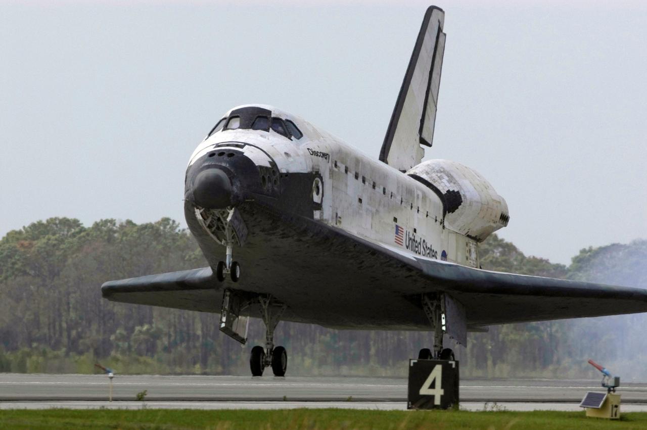 STS119-S-066 (28 March 2009) --- Space Shuttle Discovery touches down on Runway 15 of the Shuttle Landing Facility at NASA's Kennedy Space Center, concluding the 13-day, 5.3-million mile journey of the STS-119 mission to the International Space Station. Onboard are NASA astronauts Lee Archambault, commander; Tony Antonelli, pilot; Steve Swanson, Richard Arnold, Joseph Acaba, John Phillips and Sandra Magnus, all mission specialists. The main landing gear touched down at 3:13:17 p.m. (EDT) on March 28, 2009. The nose gear touched down at 3:13:40 p.m. and wheels stop was at 3:14:45 p.m. During the mission, Discovery?s crew delivered and installed the final pair of large power-generating solar array wings and the S6 truss segment to the starboard, or right, side of the station and accomplished important tasks to prepare the station for future upgrades and additions later this year.