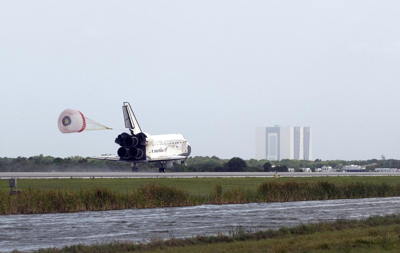 STS119-S-069 (28 March 2009) --- Space Shuttle Discovery?s drag chute is deployed as the spacecraft rolls toward wheels stop on Runway 15 of the Shuttle Landing Facility at NASA's Kennedy Space Center, concluding the 13-day, 5.3-million mile journey of the STS-119 mission to the International Space Station. Onboard are NASA astronauts Lee Archambault, commander; Tony Antonelli, pilot; Steve Swanson, Richard Arnold, Joseph Acaba, John Phillips and Sandra Magnus, all mission specialists. The main landing gear touched down at 3:13:17 p.m. (EDT) on March 28, 2009. The nose gear touched down at 3:13:40 p.m. and wheels stop was at 3:14:45 p.m. During the mission, Discovery?s crew delivered and installed the final pair of large power-generating solar array wings and the S6 truss segment to the starboard, or right, side of the station and accomplished important tasks to prepare the station for future upgrades and additions later this year.
