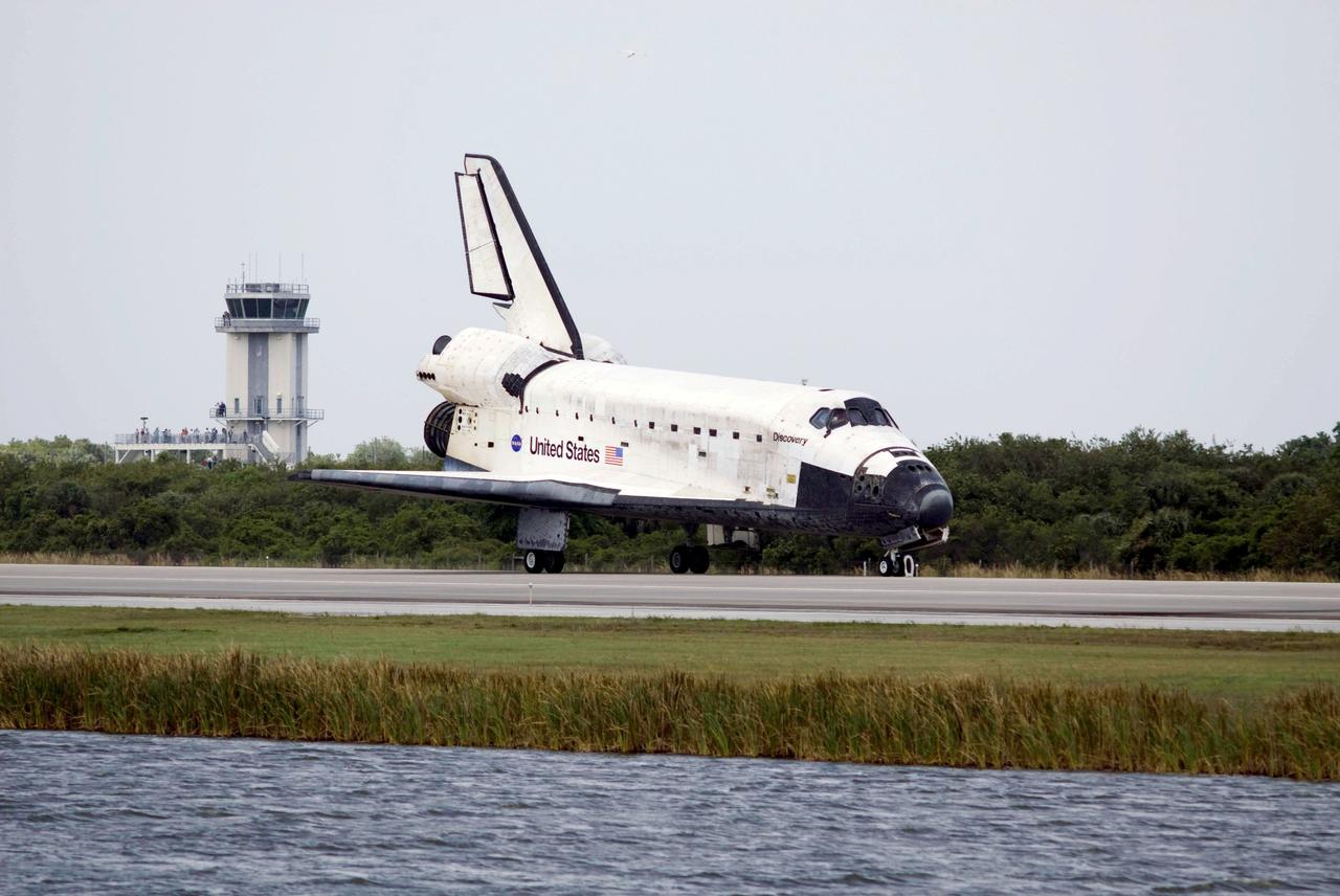 STS119-S-076 (28 March 2009) --- Space Shuttle Discovery passes the control tower on Runway 15 at NASA's Kennedy Space Center in Florida as it touches down on March 28, 2009, concluding the 13-day, 5.3-million mile journey of the STS-119 mission to the International Space Station. Onboard are NASA astronauts Lee Archambault, commander; Tony Antonelli, pilot; Steve Swanson, Richard Arnold, Joseph Acaba, John Phillips and Sandra Magnus, all mission specialists. The main landing gear touched down at 3:13:17 p.m. (EDT). The nose gear touched down at 3:13:40 p.m. and wheels stop was at 3:14:45 p.m. During the mission, Discovery?s crew delivered and installed the final pair of large power-generating solar array wings and the S6 truss segment to the starboard, or right, side of the station and accomplished important tasks to prepare the station for future upgrades and additions later this year.