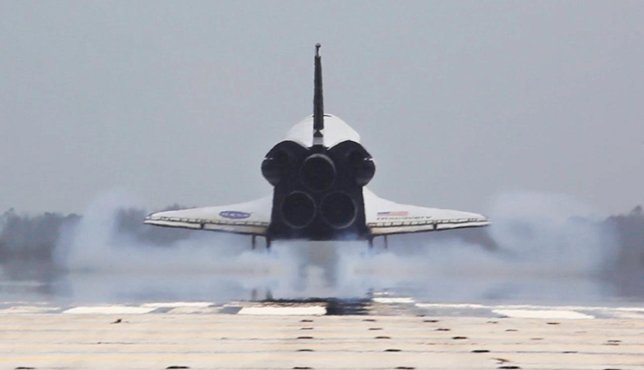 STS119-S-079 (28 March 2009) --- Space shuttle Discovery touches down on Runway 15 of the Shuttle Landing Facility at NASA's Kennedy Space Center, concluding the 13-day, 5.3-million mile journey of the STS-119 mission to the International Space Station. Onboard are NASA astronauts Lee Archambault, commander; Tony Antonelli, pilot; Steve Swanson, Richard Arnold, Joseph Acaba, John Phillips and Sandra Magnus, all mission specialists. The main landing gear touched down at 3:13:17 p.m. (EDT) on March 28, 2009. The nose gear touched down at 3:13:40 p.m. and wheels stop was at 3:14:45 p.m. During the mission, Discovery?s crew delivered and installed the final pair of large power-generating solar array wings and the S6 truss segment to the starboard, or right, side of the station and accomplished important tasks to prepare the station for future upgrades and additions later this year. Photo credit: NASA or National Aeronautics and Space Administration