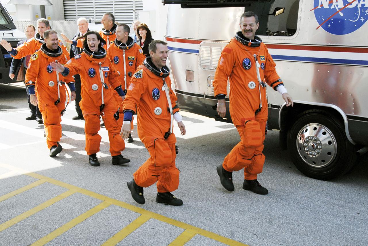 STS125-S-010 (11 May 2009) --- After suiting up, the STS-125 crewmembers exit the Operations and Checkout Building to board the Astrovan, which will take them to launch pad 39A for the launch of Space Shuttle Atlantis on the STS-125 mission to service the Hubble Space Telescope. From the right are astronauts Scott Altman, commander; Gregory C. Johnson, pilot; Megan McArthur, John Grunsfeld, Andrew Feustel, Michael Good and Mike Massimino, all mission specialists. Atlantis' 11-day flight will include five spacewalks to refurbish and upgrade the telescope with state-of-the-art science instruments that will expand Hubble's capabilities and extend its operational lifespan through at least 2014. The payload includes Wide Field Camera 3, fine guidance sensor and the Cosmic Origins Spectrograph. Launch of Atlantis is scheduled for 2:01 p.m. May 11 EDT.