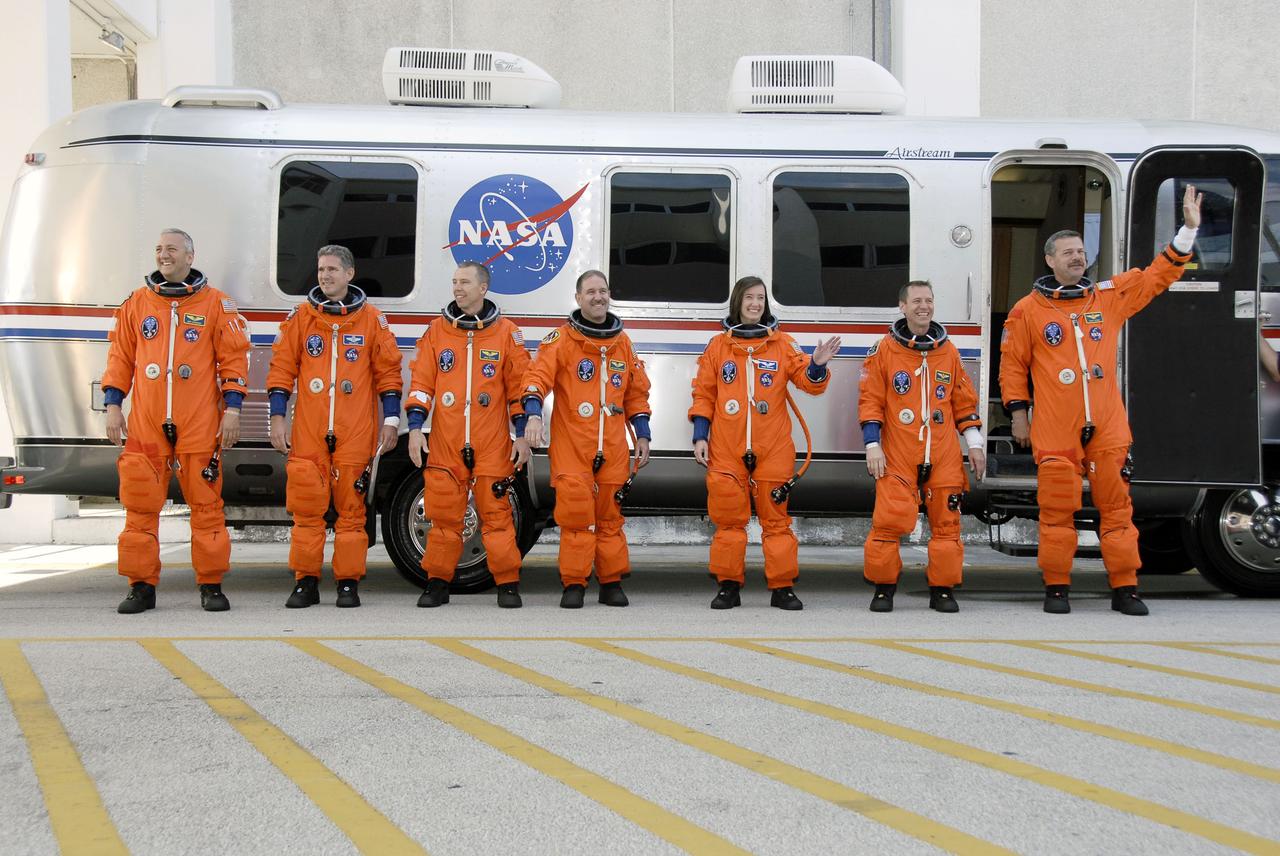 STS125-S-011 (11 May 2009) --- After suiting up, the STS-125 crewmembers pause alongside the Astrovan to wave farewell to onlookers before heading for launch pad 39A for the launch of Space Shuttle Atlantis on the STS-125 mission to service the Hubble Space Telescope. From the right are Scott Altman, commander; Gregory C. Johnson, pilot; Megan McArthur, John Grunsfeld, Andrew Feustel, Michael Good and Mike Massimino, all mission specialists. Atlantis' 11-day flight will include five spacewalks to refurbish and upgrade the telescope with state-of-the-art science instruments that will expand Hubble's capabilities and extend its operational lifespan through at least 2014. The payload includes Wide Field Camera 3, fine guidance sensor and the Cosmic Origins Spectrograph. Launch of Atlantis is scheduled for 2:01 p.m. May 11 EDT.