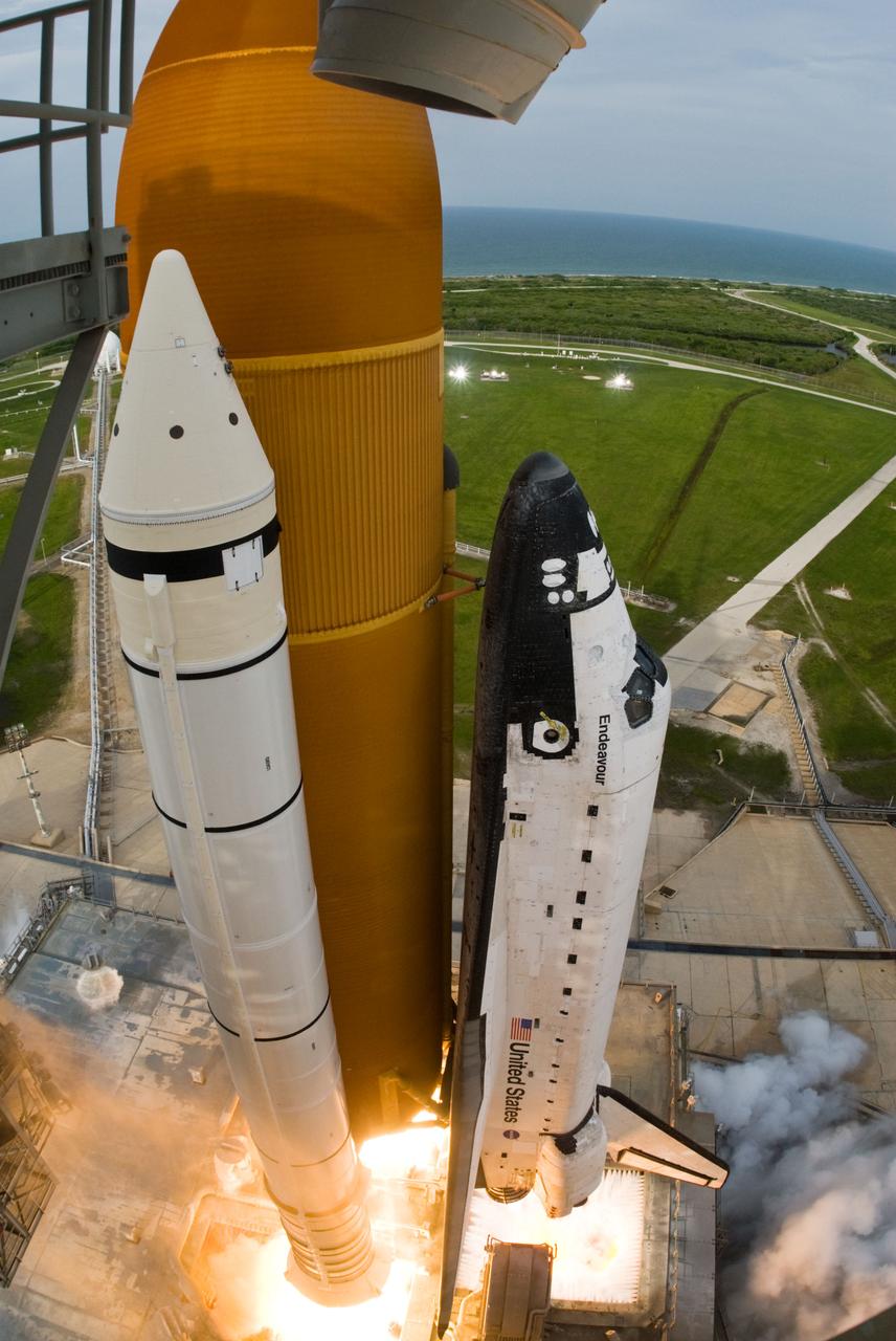 STS127-S-046 (15 July 2009) --- Captured by a remote camera equipped with a special "fish-eye" lens, Space Shuttle Endeavour and its seven-member STS-127 crew head toward Earth orbit and rendezvous with the International Space Station. Liftoff was on time at 6:03 p.m. (EDT) on July 15, 2009 from launch pad 39A at NASA?s Kennedy Space Center. Onboard are astronauts Mark Polansky, commander; Doug Hurley, pilot; Christopher Cassidy, Tom Marshburn, Dave Wolf, Tim Kopra and Canadian Space Agency?s Julie Payette, all mission specialists. Kopra will join Expedition 20 in progress to serve as a flight engineer aboard the ISS. Endeavour will deliver the Japanese Experiment Module's Exposed Facility and the Experiment Logistics Module-Exposed Section in the final of three flights dedicated to the assembly of the Japan Aerospace Exploration Agency's Kibo laboratory complex on the space station.