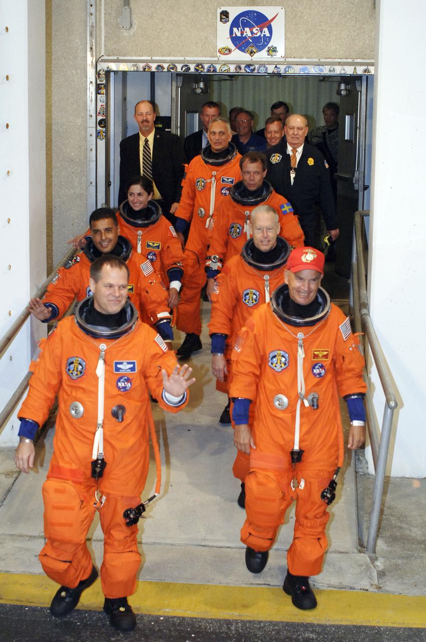 STS128-S-005 (28 Aug. 2009) --- After suiting up, the STS-128 crew members exit the Operations and Checkout Building to board the Astrovan, which will take them to launch pad 39A for the launch of Space Shuttle Discovery on the STS-128 mission. On the right (front to back) are astronauts Rick Sturckow, commander; Patrick Forrester, European Space Agency astronaut Christer Fuglesang and John ?Danny? Olivas, all mission specialists. On the left (front to back) are astronauts Kevin Ford, pilot; Jose Hernandez and Nicole Stott, both mission specialists. Stott will join Expedition 20 in progress to serve as a flight engineer aboard the International Space Station. The 13-day mission will deliver more than seven tons of supplies, science racks and equipment, as well as additional environmental hardware to sustain six crew members on the space station. The equipment includes a freezer to store research samples, a new sleeping compartment and the COLBERT treadmill. The mission is the 128th in the Space Shuttle Program, the 37th flight of Discovery and the 30th station assembly flight.