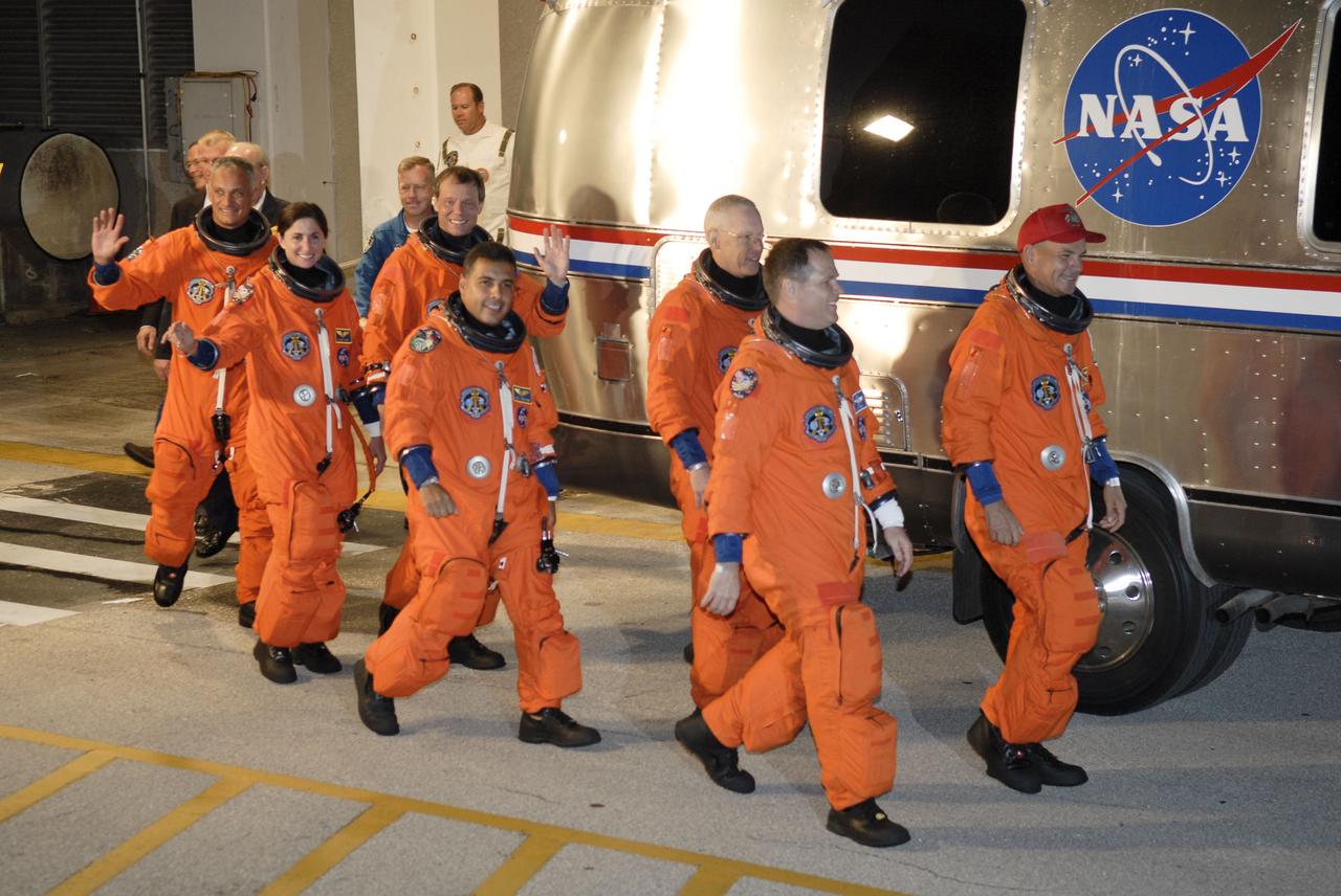 STS128-S-007 (28 Aug. 2009) --- After suiting up, the STS-128 crew members exit the Operations and Checkout Building to board the Astrovan, which will take them to launch pad 39A for the launch of Space Shuttle Discovery on the STS-128 mission. From right to left are astronauts Rick Sturckow, commander; Kevin Ford, pilot; Patrick Forrester, Jose Hernandez, European Space Agency astronaut Christer Fuglesang, Nicole Stott and John ?Danny? Olivas, all mission specialists. Stott will join Expedition 20 in progress to serve as a flight engineer aboard the International Space Station. The 13-day mission will deliver more than seven tons of supplies, science racks and equipment, as well as additional environmental hardware to sustain six crew members on the space station. The equipment includes a freezer to store research samples, a new sleeping compartment and the COLBERT treadmill. The mission is the 128th in the Space Shuttle Program, the 37th flight of Discovery and the 30th station assembly flight.