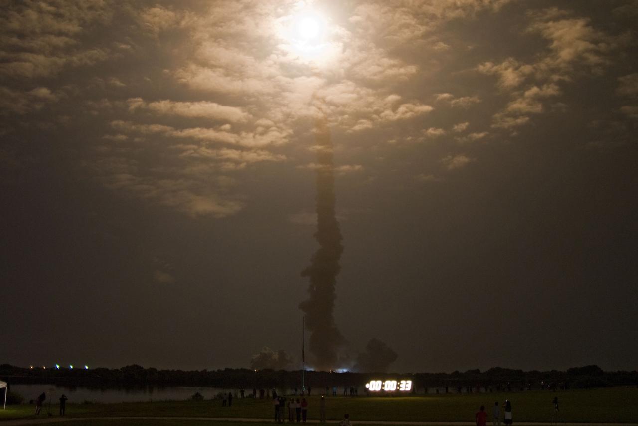STS128-S-012 (28 Aug. 2009) --- Lighting up the clouds in the night sky, Space Shuttle Discovery and its seven-member STS-128 crew head toward Earth orbit and rendezvous with the International Space Station (ISS). Liftoff was on time at 11:59 p.m. (EDT) on Aug. 28, 2009 from launch pad 39A at NASA?s Kennedy Space Center. Onboard are astronauts Rick Sturckow, commander; Kevin Ford, pilot; John ?Danny? Olivas, European Space Agency astronaut Christer Fuglesang, Patrick Forrester, Jose Hernandez and Nicole Stott, all mission specialists. Stott will join Expedition 20 in progress to serve as a flight engineer aboard the ISS. The 13-day mission will deliver more than seven tons of supplies, science racks and equipment, as well as additional environmental hardware to sustain six crew members on the space station. The equipment includes a freezer to store research samples, a new sleeping compartment and the COLBERT treadmill. The mission is the 128th in the Space Shuttle Program, the 37th flight of Discovery and the 30th station assembly flight.