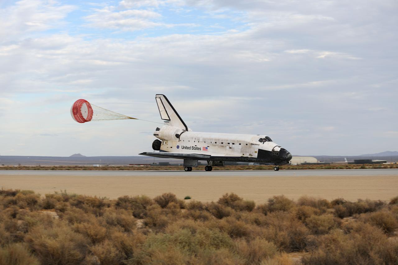 STS128-S-048 (11 Sept. 2009) --- With its drag chute deployed, Space Shuttle Discovery slows to a stop after landing at NASA's Dryden Flight Research Center at Edwards Air Force Base in California, concluding a successful mission to the International Space Station. Onboard are NASA astronauts Rick Sturckow, commander; Kevin Ford, pilot; John ?Danny? Olivas, Patrick Forrester, Jose Hernandez and Tim Kopra, all mission specialists; along with European Space Agency astronaut Christer Fuglesang, mission specialist. Discovery landed at 5:53 p.m. (PDT) on Sept. 11, 2009 to end the STS-128 mission, completing its almost 14-day journey of more than 5.7 million miles in space. The landing was diverted to California due to marginal weather at the Kennedy Space Center. Discovery?s mission featured three spacewalks and the delivery of two refrigerator-sized science racks to the space station. One rack will be used to conduct experiments on materials such as metals, glasses and ceramics. The results from these experiments could lead to the development of better materials on Earth. The other rack will be used for fluid physics research. Understanding how fluids react in microgravity could lead to improved designs for fuel tanks, water systems and other fluid-based systems.