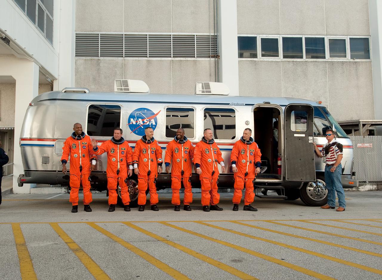 STS-129 crew members, from left, Robert Satcher, Mike Foreman, Randy Bresnik, Leland Melvin, Pilot Barry Wilmore, and Mission Commander Charlie Hobaugh stop and pose for a photograph before getting into the astrovan and heading to launch pad 39a at the NASA Kennedy Space Center in Cape Canaveral, Fl on Monday, Nov. 16, 2009.  Photo Credit: (NASA/Bill Ingalls)
