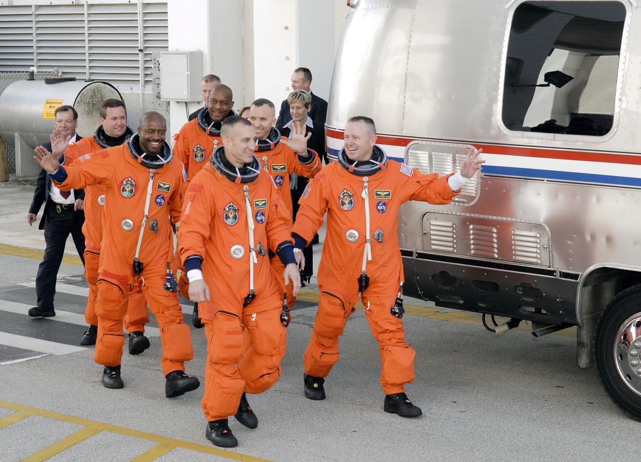 CAPE CANAVERAL, Fla. - At NASA's Kennedy Space Center in Florida, the astronauts on the STS-129 crew, dressed in their orange launch-and-entry suits, wave to spectators as they walk out of the Operations and Checkout Building for the 15-minute ride in the Astrovan to Launch Pad 39A. From left are Mission Specialists Mike Foreman, Leland Melvin and Robert L. Satcher Jr.; Commander Charles O. Hobaugh; Mission Specialist Randy Bresnik; and Pilot Barry E. Wilmore. Liftoff is set for 2:28 p.m. EST Nov. 16. On STS-129, the crew will deliver two Express Logistics Carriers to the International Space Station, the largest of the shuttle's cargo carriers, containing 15 spare pieces of equipment including two gyroscopes, two nitrogen tank assemblies, two pump modules, an ammonia tank assembly and a spare latching end effector for the station's robotic arm. Atlantis will return to Earth a station crew member, Nicole Stott, who has spent more than two months aboard the orbiting laboratory. STS-129 is slated to be the final space shuttle Expedition crew rotation flight. For information on the STS-129 mission and crew, visit http://www.nasa.gov/mission_pages/shuttle/shuttlemissions/sts129/index.html. Photo credit: NASA/Kim Shiflett  