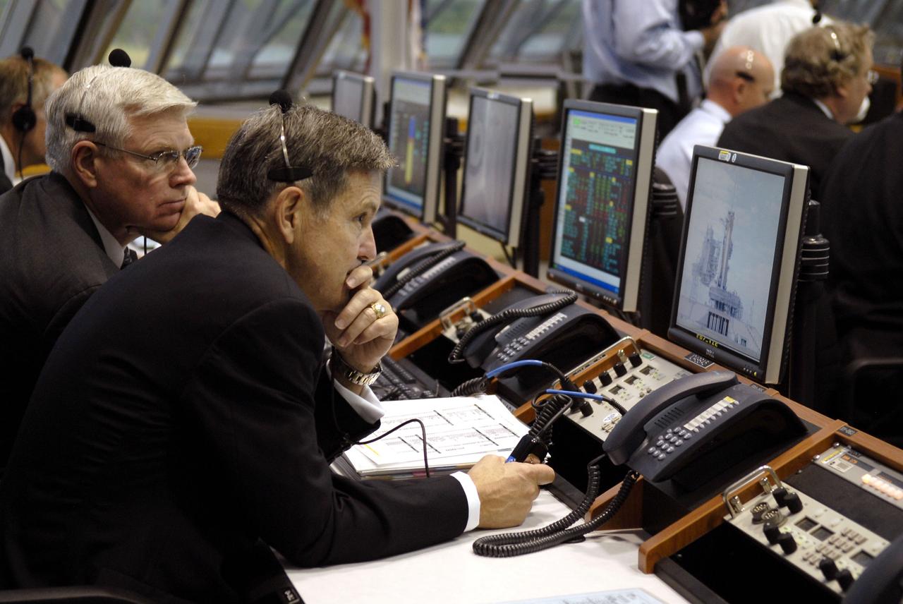 STS129-S-054 (16 Nov. 2009) --- Michael Coats (left), director of NASA's Johnson Space Center in Houston; and Bob Cabana, director of NASA's Kennedy Space Center in Florida, monitor the progress of Space Shuttle Atlantis' countdown from consoles in the Operations Management Room, a glass partitioned area overlooking the main floor of Firing Room 4, in Kennedy's Launch Control Center. Liftoff of Atlantis from Launch Pad 39A on its STS-129 mission to the International Space Station came at 2:28 p.m. (EST) on Nov. 16, 2009.