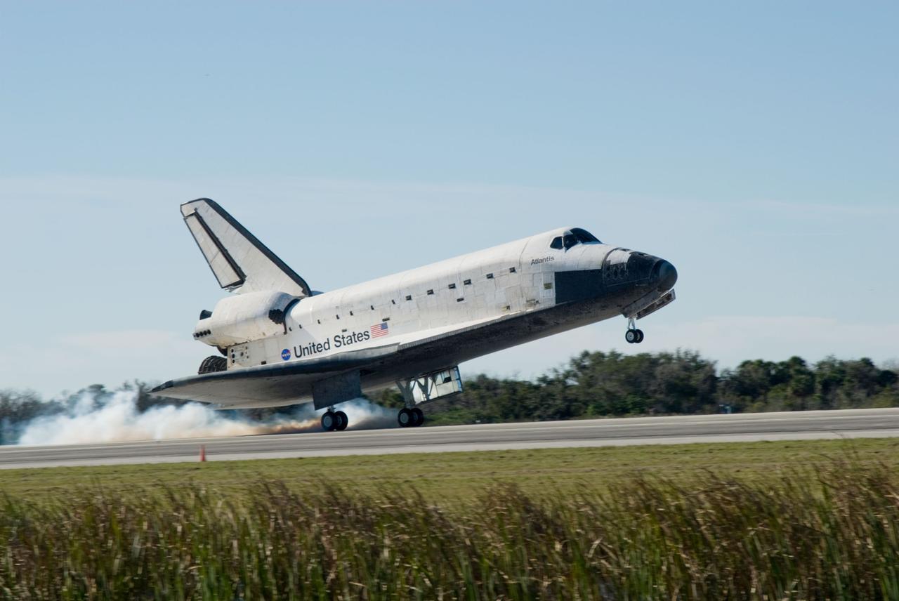 PHOTO CREDIT: NASA or National Aeronautics and Space Administration CAPE CANAVERAL, Fla. - Streams of smoke trail from the main landing gear tires as space shuttle Atlantis touches down on Runway 33 at the Shuttle Landing Facility at NASA's Kennedy Space Center in Florida after 11 days in space, completing the 4.5-million-mile STS-129 mission on orbit 171. Main gear touchdown was at 9:44:23 a.m. EDT. Nose gear touchdown was at 9:44:36 a.m., and wheels stop was at 9:45:05 a.m. Aboard Atlantis are Commander Charles O. Hobaugh; Pilot Barry E. Wilmore; Mission Specialists Leland Melvin, Randy Bresnik, Mike Foreman and Robert L. Satcher Jr.; and Expedition 20 and 21 Flight Engineer Nicole Stott who spent 87 days aboard the International Space Station. STS-129 is the final space shuttle Expedition crew rotation flight on the manifest. On STS-129, the crew delivered 14 tons of cargo to the orbiting laboratory, including two ExPRESS Logistics Carriers containing spare parts to sustain station operations after the shuttles are retired next year. For information on the STS-129 mission and crew, visit http://www.nasa.gov/mission_pages/shuttle/shuttlemissions/sts129/index.html. Photo credit: NASA/Jim Grossmann