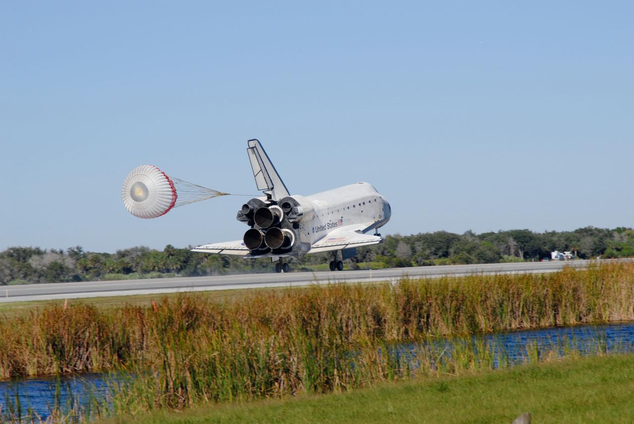PHOTO CREDIT:   NASA or National Aeronautics and Space Administration  CAPE CANAVERAL, Fla. - The drag chute unfurls to slow space shuttle Atlantis for landing on Runway 33 at the Shuttle Landing Facility at NASA's Kennedy Space Center in Florida after 11 days in space, completing the 4.5-million mile STS-129 mission on orbit 171. Main gear touchdown was at 9:44:23 a.m. EDT. Nose gear touchdown was at 9:44:36 a.m., and wheels stop was at 9:45:05 a.m. Aboard Atlantis are Commander Charles O. Hobaugh; Pilot Barry E. Wilmore; Mission Specialists Leland Melvin, Randy Bresnik, Mike Foreman and Robert L. Satcher Jr.; and Expedition 20 and 21 Flight Engineer Nicole Stott who spent 87 days aboard the International Space Station. STS-129 is the final space shuttle Expedition crew rotation flight on the manifest. On STS-129, the crew delivered 14 tons of cargo to the orbiting laboratory, including two ExPRESS Logistics Carriers containing spare parts to sustain station operations after the shuttles are retired next year. For information on the STS-129 mission and crew, visit http://www.nasa.gov/mission_pages/shuttle/shuttlemissions/sts129/index.html. Photo credit: NASA/Jim Grossmann
