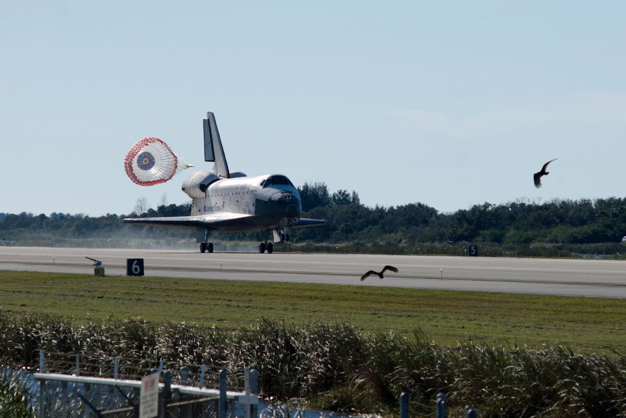 PHOTO CREDIT:   NASA or National Aeronautics and Space Administration  CAPE CANAVERAL, Fla. - The drag chute unfurls to slow space shuttle Atlantis for landing on Runway 33 at the Shuttle Landing Facility at NASA's Kennedy Space Center in Florida after 11 days in space, completing the 4.5-million mile STS-129 mission on orbit 171. Main gear touchdown was at 9:44:23 a.m. EDT. Nose gear touchdown was at 9:44:36 a.m., and wheels stop was at 9:45:05 a.m. Aboard Atlantis are Commander Charles O. Hobaugh; Pilot Barry E. Wilmore; Mission Specialists Leland Melvin, Randy Bresnik, Mike Foreman and Robert L. Satcher Jr.; and Expedition 20 and 21 Flight Engineer Nicole Stott who spent 87 days aboard the International Space Station. STS-129 is the final space shuttle Expedition crew rotation flight on the manifest. On STS-129, the crew delivered 14 tons of cargo to the orbiting laboratory, including two ExPRESS Logistics Carriers containing spare parts to sustain station operations after the shuttles are retired next year. For information on the STS-129 mission and crew, visit http://www.nasa.gov/mission_pages/shuttle/shuttlemissions/sts129/index.html. Photo credit: NASA/Sandra Joseph