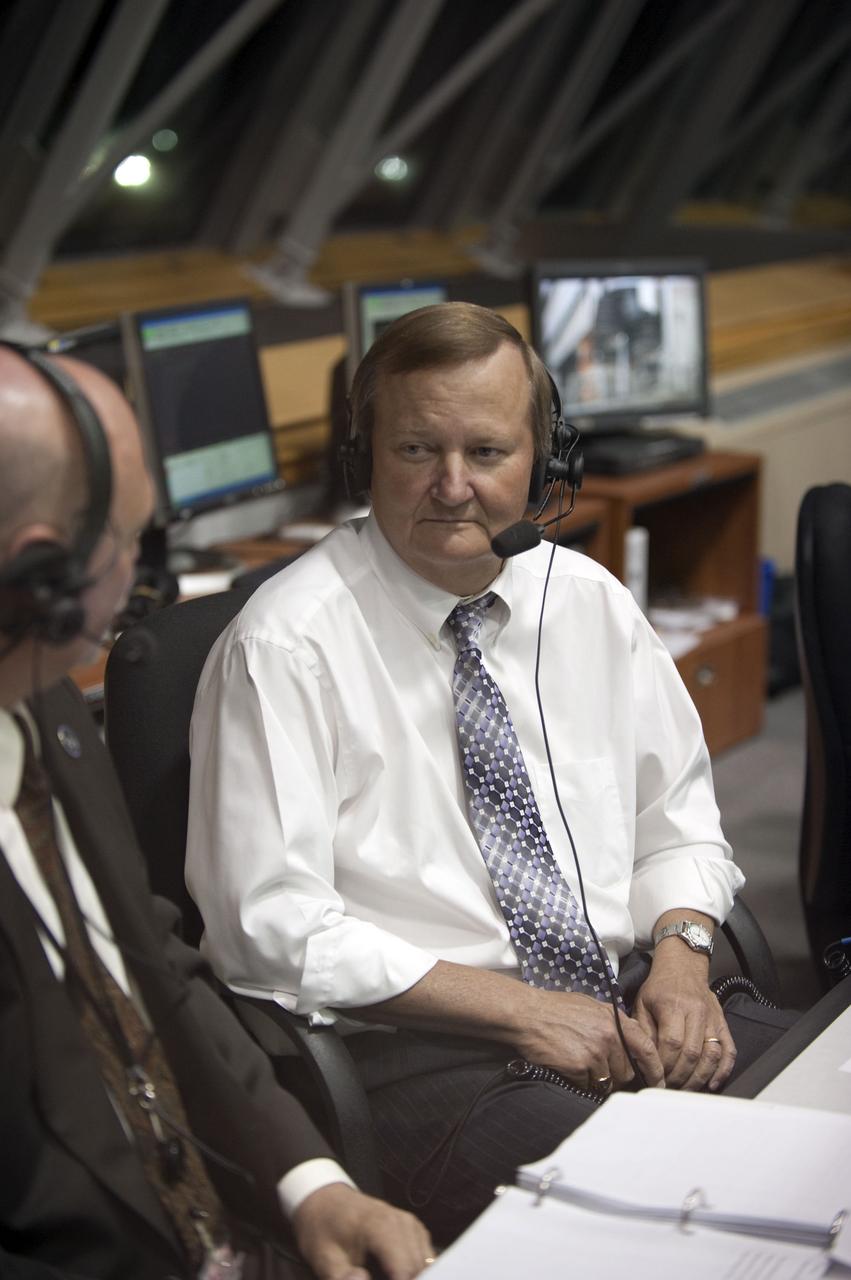 STS131-S-055 (5 April 2010) --- Assistant Launch Director Mike Leinbach (right) speaks with NASA commentator Mike Curie in Firing Room 4 in the Launch Control Center at NASA's Kennedy Space Center in Florida prior to the launch of space shuttle Discovery's STS-131 mission. The seven-member STS-131 crew will deliver the multi-purpose logistics module Leonardo, filled with supplies, a new crew sleeping quarters and science racks that will be transferred to the International Space Station's laboratories. The crew also will switch out a gyroscope on the station’s truss structure, install a spare ammonia storage tank and retrieve a Japanese experiment from the station’s exterior. STS-131 is the 33rd shuttle mission to the station and the 131st shuttle mission overall.