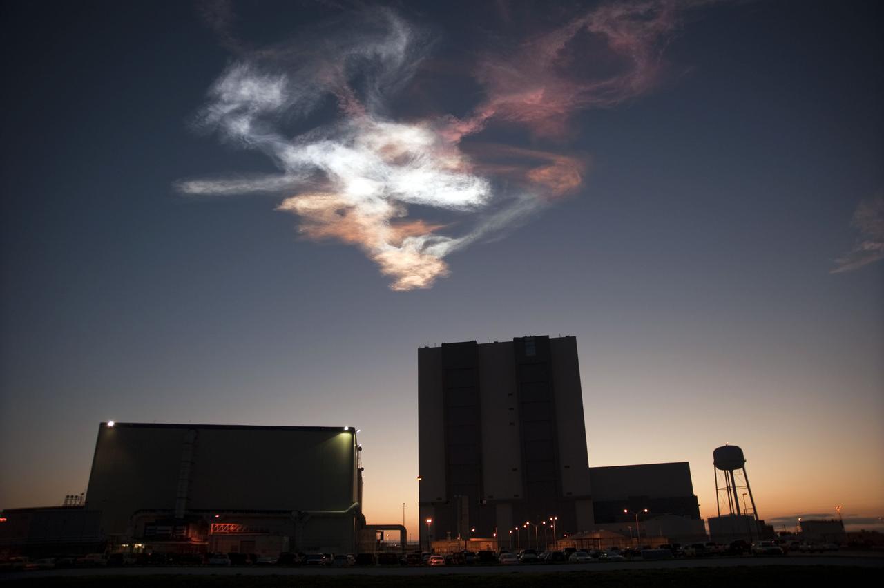 STS131-S-059 (5 April 2010) --- Drifting smoke plumes from the launch of space shuttle Discovery (out of frame) swirl above the Vehicle Assembly Building at NASA's Kennedy Space Center in Florida. Discovery and its seven-member STS-131 crew head toward Earth-orbit and a scheduled link-up with the International Space Station. Liftoff from Kennedy Space Center's launch pad 39A occurred at 6:21 a.m. (EDT) on April 5, 2010. Onboard are NASA astronauts Alan Poindexter, commander; James P. Dutton Jr., pilot; Rick Mastracchio, Dorothy Metcalf-Lindenburger, Stephanie Wilson and Clayton Anderson; along with Japan Aerospace Exploration Agency (JAXA) astronaut Naoko Yamazaki, all mission specialists. The crew will deliver the multi-purpose logistics module Leonardo, filled with supplies, a new crew sleeping quarters and science racks that will be transferred to the International Space Station's laboratories. The crew also will switch out a gyroscope on the station’s truss structure, install a spare ammonia storage tank and retrieve a Japanese experiment from the station’s exterior. STS-131 is the 33rd shuttle mission to the station and the 131st shuttle mission overall.