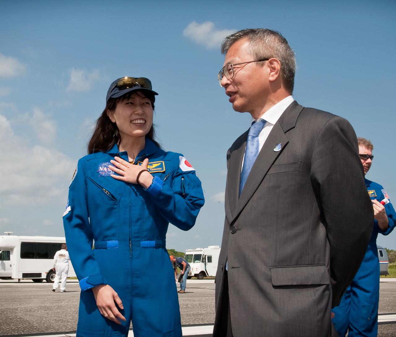 STS131-S-092 (20 April 2010) --- Japanese astronaut Naoko Yamazaki, left, and Dr. Kuniaki Shiraki, Executive Director, Japan Aerospace Exploration Agency (JAXA), talk near the space shuttle Discovery shortly after Discovery and the STS-131 crew landed at the Kennedy Space Center in Cape Canaveral, Fla., on April 20, 2010. NASA astronauts Alan Poindexter, commander; James P. Dutton Jr., pilot; Dorothy Metcalf-Lindenburger, Rick Mastracchio, Stephanie Wilson, Clayton Anderson and Japanese astronaut Naoko Yamazaki, all mission specialists, returned from their 15-day journey of more than 6.2 million miles. The STS-131 mission to the International Space Station delivered science racks, new crew sleeping quarters, equipment and supplies. Photo credit: NASA/Bill Ingalls