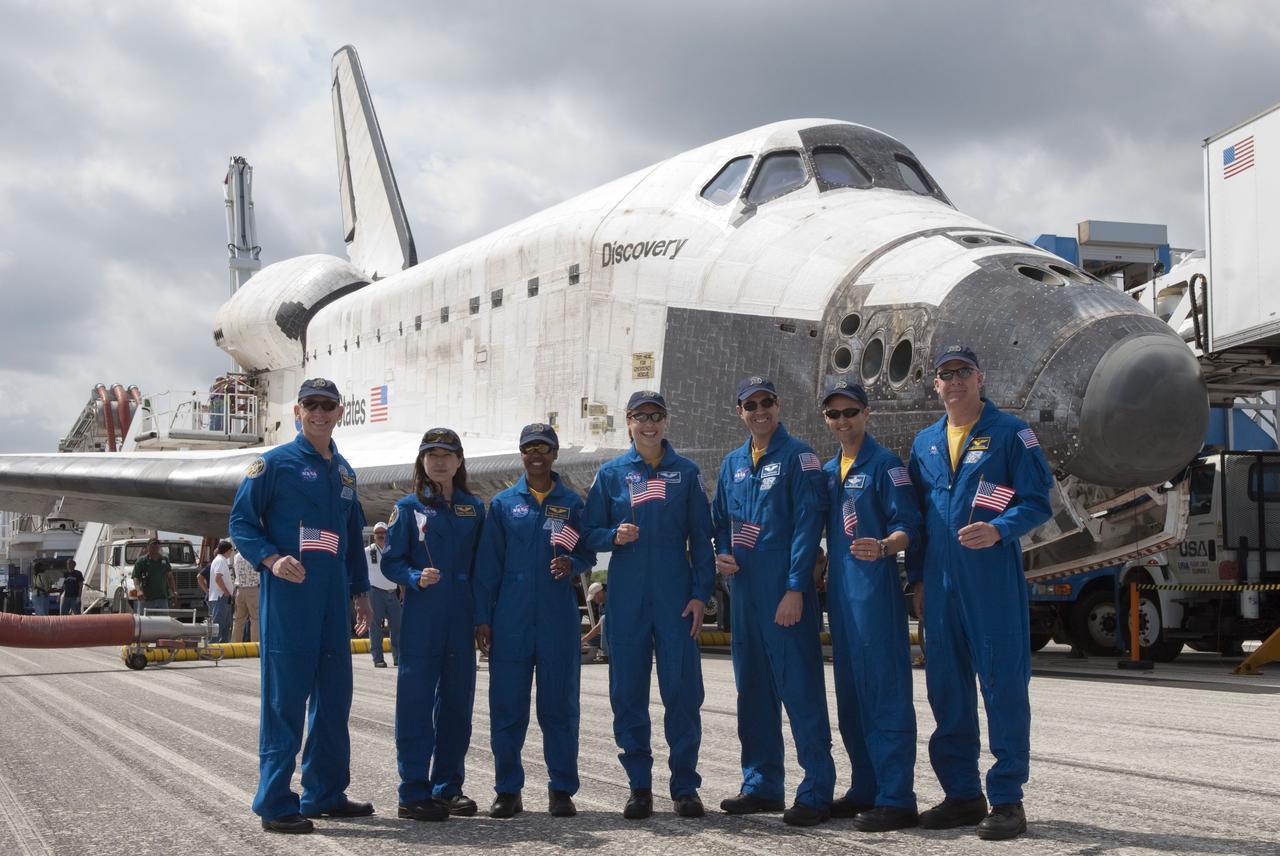STS131-S-144 (20 April 2010) --- At the Shuttle Landing Facility at NASA's Kennedy Space Center in Florida, members of the STS-131 crew, each holding a flag from his or her country of origin, pose for a portrait in front of space shuttle Discovery. From the right are NASA astronauts Alan Poindexter, commander; James P. Dutton Jr., pilot; Rick Mastracchio, Dorothy Metcalf-Lindenburger, Stephanie Wilson, Japanese astronaut Naoko Yamazaki and NASA astronaut Clayton Anderson, all mission specialists. Discovery landed on Runway 33 after 15 days in space, completing the more than 6.2-million-mile STS-131 mission on orbit 238. Main gear touchdown was at 9:08:35 a.m. (EDT) on April 20, 2010, followed by nose gear touchdown at 9:08:47 a.m. and wheelstop at 9:09:33 a.m. The seven-member STS-131 crew carried the Leonardo Multi-Purpose Logistics Module, filled with supplies, a new crew sleeping quarters and science racks that were transferred to the International Space Station's laboratories. The crew also switched out a gyroscope on the station?s truss, installed a spare ammonia storage tank and retrieved a Japanese experiment from the station?s exterior. STS-131 is the 33rd shuttle mission to the station and the 131st shuttle mission overall.