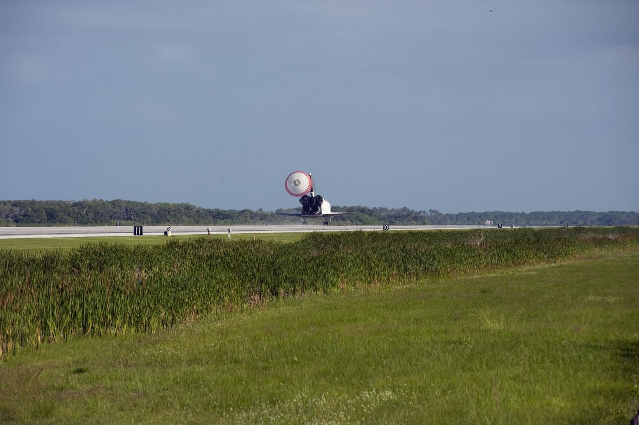 STS132-S-086 (26 May 2010) --- Space shuttle Atlantis? drag chute is deployed as the spacecraft rolls toward wheels stop on Runway 33 at the Shuttle Landing Facility at NASA's Kennedy Space Center in Florida. Landing was at 8:48 a.m. (EDT) on May 26, 2010, completing the 12-day STS-132 mission to the International Space Station. Main gear touchdown was at 8:48:11 a.m., followed by nose gear touchdown at 8:48:21 a.m. and wheelstop at 8:49:18 a.m. Onboard are NASA astronauts Ken Ham, commander; Tony Antonelli, pilot; Garrett Reisman, Michael Good, Steve Bowen and Piers Sellers, all mission specialists. The six-member STS-132 crew carried the Russian-built Mini Research Module 1 (MRM1) to the orbital complex. STS-132 is the 34th shuttle mission to the station, the 132nd shuttle mission overall and the last planned flight for Atlantis.