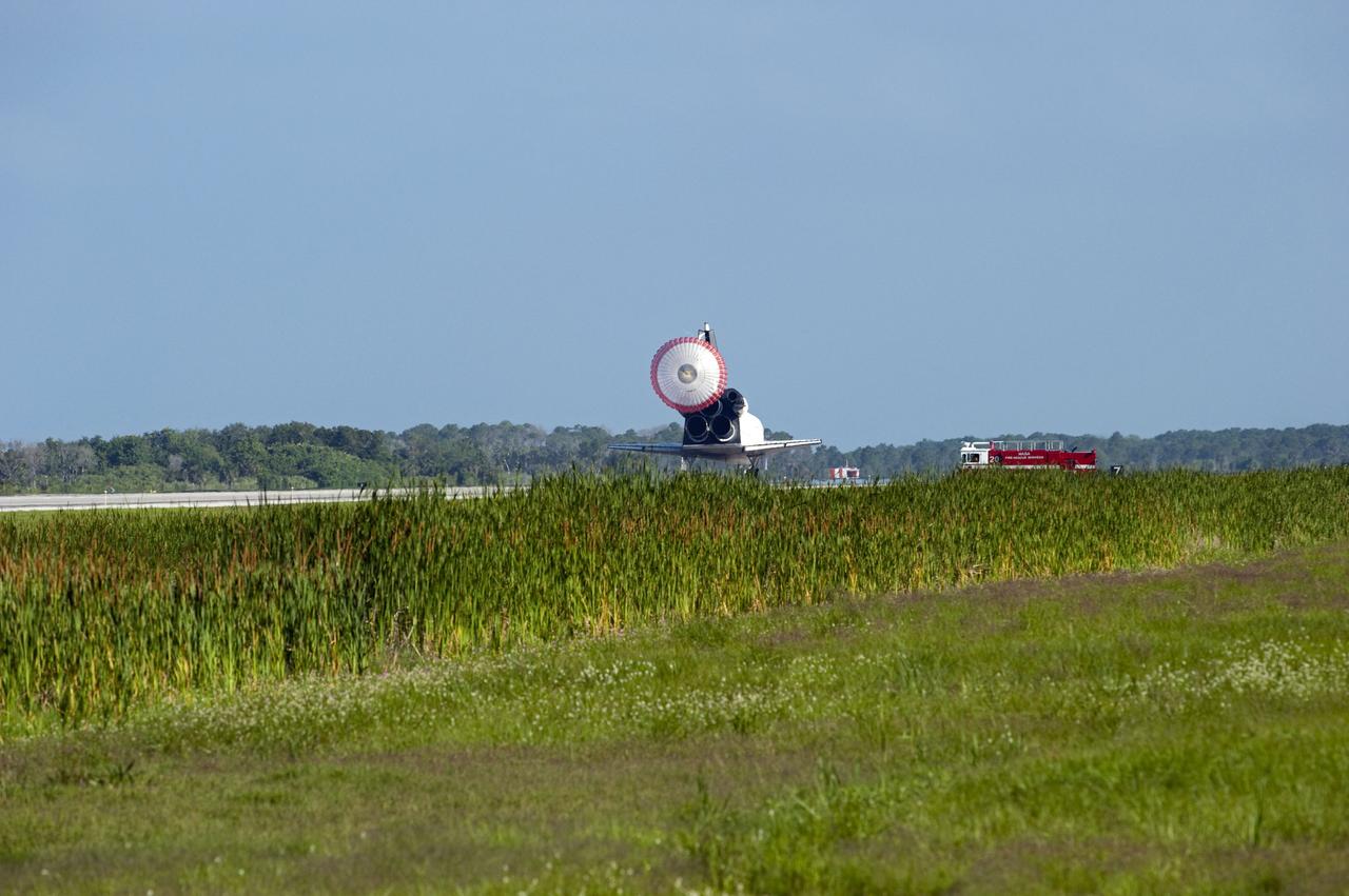 STS132-S-116 (26 May 2010) --- Space shuttle Atlantis? drag chute is deployed as the spacecraft rolls toward wheels stop on Runway 33 at the Shuttle Landing Facility at NASA's Kennedy Space Center in Florida. Landing was at 8:48 a.m. (EDT) on May 26, 2010, completing the 12-day STS-132 mission to the International Space Station. Main gear touchdown was at 8:48:11 a.m., followed by nose gear touchdown at 8:48:21 a.m. and wheelstop at 8:49:18 a.m. Onboard are NASA astronauts Ken Ham, commander; Tony Antonelli, pilot; Garrett Reisman, Michael Good, Steve Bowen and Piers Sellers, all mission specialists. The six-member STS-132 crew carried the Russian-built Mini Research Module 1 (MRM1) to the orbital complex. STS-132 is the 34th shuttle mission to the station, the 132nd shuttle mission overall and the last planned flight for Atlantis.