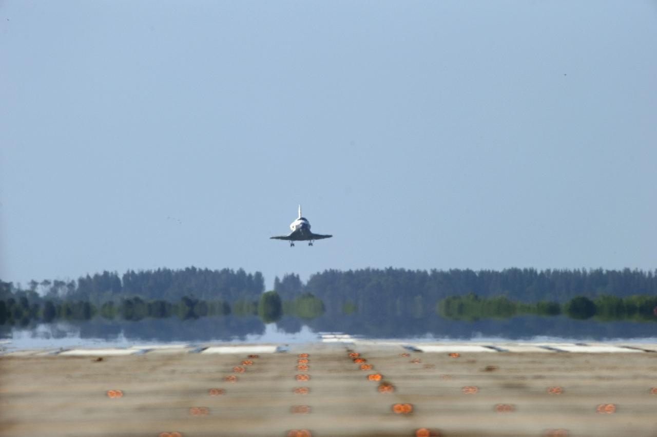 STS132-S-129 (26 May 2010) --- Space shuttle Atlantis approaches Runway 33 at the Shuttle Landing Facility at NASA's Kennedy Space Center in Florida. Landing was at 8:48 a.m. (EDT) on May 26, 2010, completing the 12-day STS-132 mission to the International Space Station. Main gear touchdown was at 8:48:11 a.m., followed by nose gear touchdown at 8:48:21 a.m. and wheelstop at 8:49:18 a.m. Onboard are NASA astronauts Ken Ham, commander; Tony Antonelli, pilot; Garrett Reisman, Michael Good, Steve Bowen and Piers Sellers, all mission specialists. The six-member STS-132 crew carried the Russian-built Mini Research Module 1 (MRM1) to the orbital complex. STS-132 is the 34th shuttle mission to the station, the 132nd shuttle mission overall and the last planned flight for Atlantis.