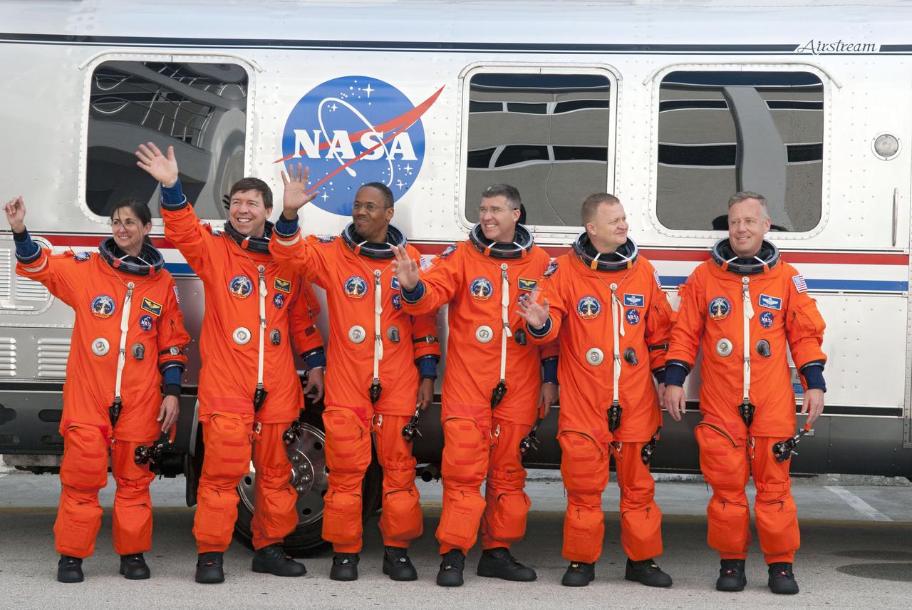 STS133-S-007 (24 Feb. 2011) --- After suiting up, the STS-133 crew members pause alongside the Astrovan to wave farewell to onlookers before heading for launch pad 39A for the launch of space shuttle Discovery on the STS-133 mission. From the right are NASA astronauts Steve Lindsey, commander; Eric Boe, pilot; Steve Bowen, Alvin Drew, Michael Barratt and Nicole Stott, all mission specialists. Discovery and its six-member crew will deliver the Permanent Multipurpose Module, packed with supplies and critical spare parts, as well as Robonaut 2, the dexterous humanoid astronaut helper, to the International Space Station. Discovery, which will fly its 39th mission, is scheduled to be retired following STS-133. This will be the 133rd Space Shuttle Program mission and the 35th shuttle voyage to the space station. Photo credit: NASA or National Aeronautics and Space Administration