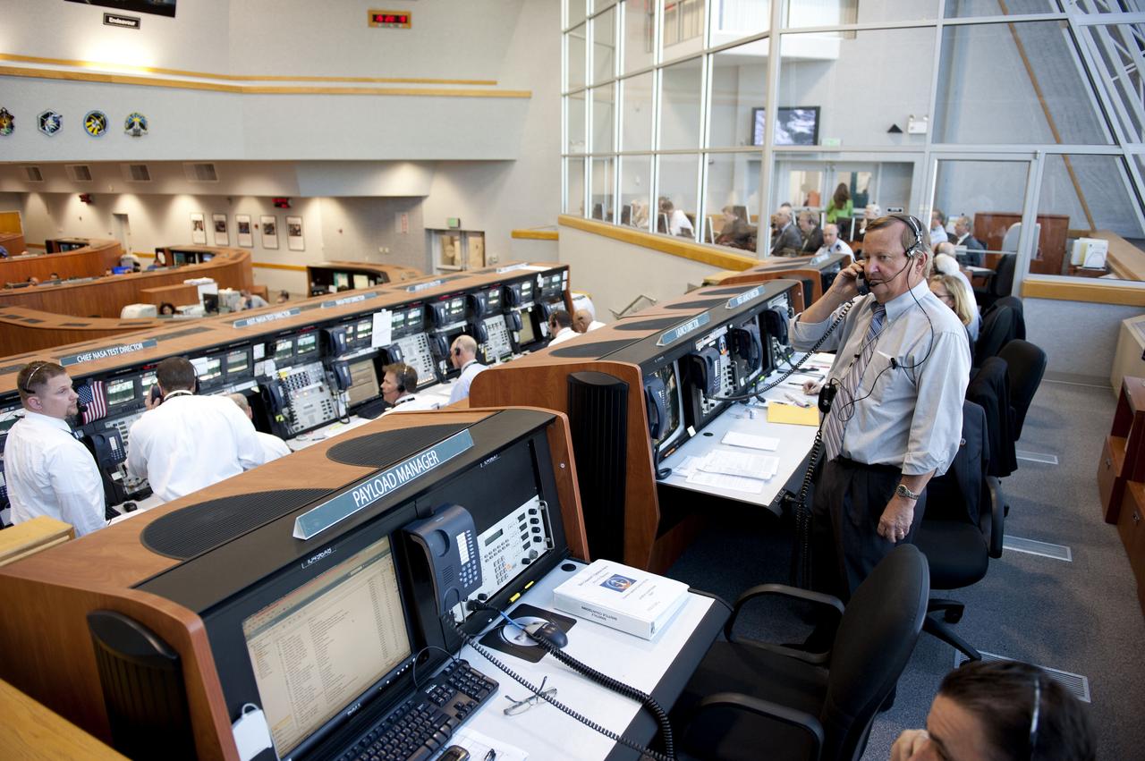 STS133-S-060 (24 Feb. 2011) --- In Firing Room 4 of the Launch Control Center at NASA's Kennedy Space Center in Florida, Shuttle Launch Director Mike Leinbach (standing at right) and his team monitor the countdown to launch of space shuttle Discovery on its STS-133 mission to the International Space Station. Discovery and its six-member crew are on a mission to deliver the Permanent Multipurpose Module, packed with supplies and critical spare parts, as well as Robonaut 2, the dexterous humanoid astronaut helper, to the orbiting outpost. Discovery is making its 39th mission and is scheduled to be retired following STS-133. This is the 133rd Space Shuttle Program mission and the 35th shuttle voyage to the space station. Photo credit: NASA or National Aeronautics and Space Administration