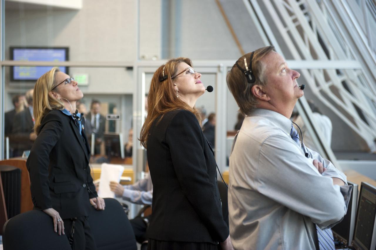 STS133-S-067 (24 Feb. 2011) --- In Firing Room 4 of the Launch Control Center at NASA's Kennedy Space Center in Florida, NASA's Discovery Flow Director Stephanie Stilson, left, STS-133 Assistant Shuttle Launch Director and lead NASA Test Director Charlie Blackwell-Thompson and Shuttle Launch Director Mike Leinbach watch space shuttle Discovery head toward Earth orbit on the STS-133 mission to the International Space Station. Discovery and its six-member crew are on a mission to deliver the Permanent Multipurpose Module, packed with supplies and critical spare parts, as well as Robonaut 2, the dexterous humanoid astronaut helper, to the orbiting outpost. Discovery is making its 39th mission and is scheduled to be retired following STS-133. This is the 133rd Space Shuttle Program mission and the 35th shuttle voyage to the space station. Photo credit: NASA or National Aeronautics and Space Administration