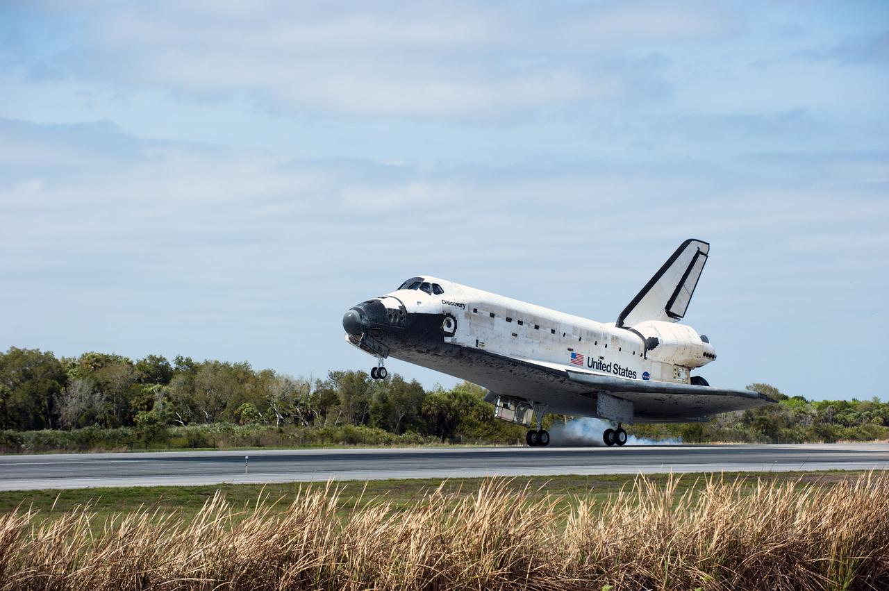 STS133-S-105 (9 March 2011) --- Space shuttle Discovery’s main gear touches down on Runway 15 at the Shuttle Landing Facility at NASA’s Kennedy Space Center in Florida. Landing was at 11:57 a.m. (EST) on March 9, 2011, completing a more than 12-day STS-133 mission to the International Space Station. Onboard are NASA astronauts Steve Lindsey, commander; Eric Boe, pilot; Steve Bowen, Alvin Drew, Michael Barratt and Nicole Stott, all mission specialists. Discovery and its six-member crew delivered the Permanent Multipurpose Module, packed with supplies and critical spare parts, as well as Robonaut 2, the dexterous humanoid astronaut helper, to the orbiting outpost. STS-133 was Discovery's 39th and final mission. This was the 133rd Space Shuttle Program mission and the 35th shuttle voyage to the space station. Photo credit: NASA or National Aeronautics and Space Administration