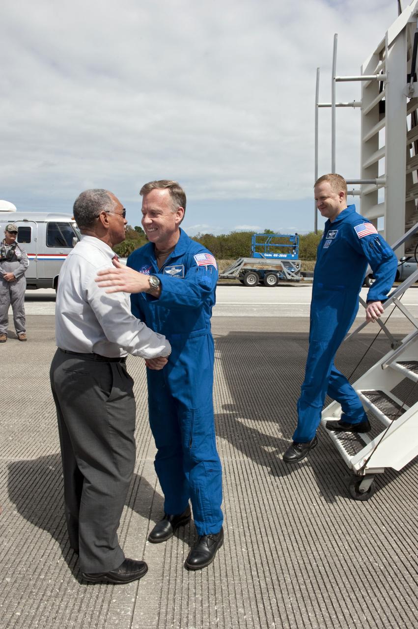 STS133-S-136 (9 March 2011) --- NASA Administrator Charlie Bolden begins to greet the STS-133 crew members as they exit the crew transport vehicle after landing at NASA's Kennedy Space Center in Florida aboard space shuttle Discovery. Leading the crew is astronaut Steve Lindsey, commander; followed by astronaut Eric Boe, pilot. Touchdown on the Shuttle Landing Facility's Runway 15 was at 11:57 a.m. (EST) on March 9, 2011, bringing an end to the 13-day STS-133 mission to the International Space Station. Discovery and its six-member crew delivered the Permanent Multipurpose Module, packed with supplies and critical spare parts, as well as Robonaut 2, the dexterous humanoid astronaut helper, to the orbiting outpost. STS-133 was Discovery's 39th and final mission. This was the 133rd Space Shuttle Program mission and the 35th shuttle voyage to the space station. Photo credit: NASA or National Aeronautics and Space Administration