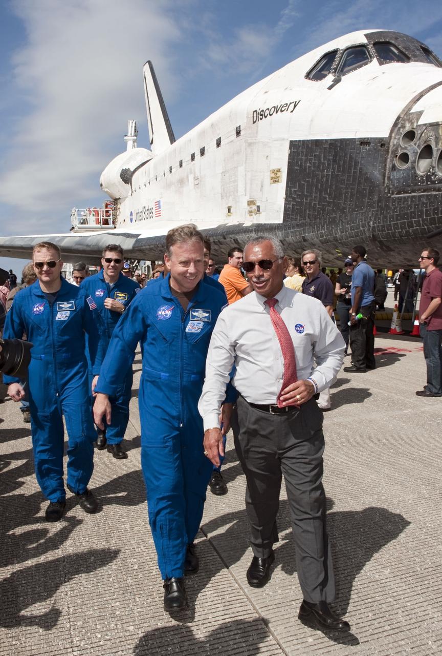 STS133-S-151 (9 March 2011) --- NASA Administrator Charlie Bolden leads the STS-133 crew to media representatives waiting on the Shuttle Landing Facility at Kennedy Space Center in Florida to hear statements about space shuttle Discovery's final spaceflight mission. The STS-133 crew returned to Earth at 11:57 a.m. (EST) on March 9, 2011, on Runway 15, completing a 13-day, 5.3-million-mile mission to the International Space Station. STS-133 delivered the Permanent Multipurpose Module, packed with supplies and critical spare parts, as well as Robonaut 2, the dexterous humanoid astronaut helper, to the orbiting outpost. STS-133 was Discovery's 39th and final mission. This was the 133rd Space Shuttle Program mission and the 35th shuttle voyage to the space station. Photo credit: NASA or National Aeronautics and Space Administration