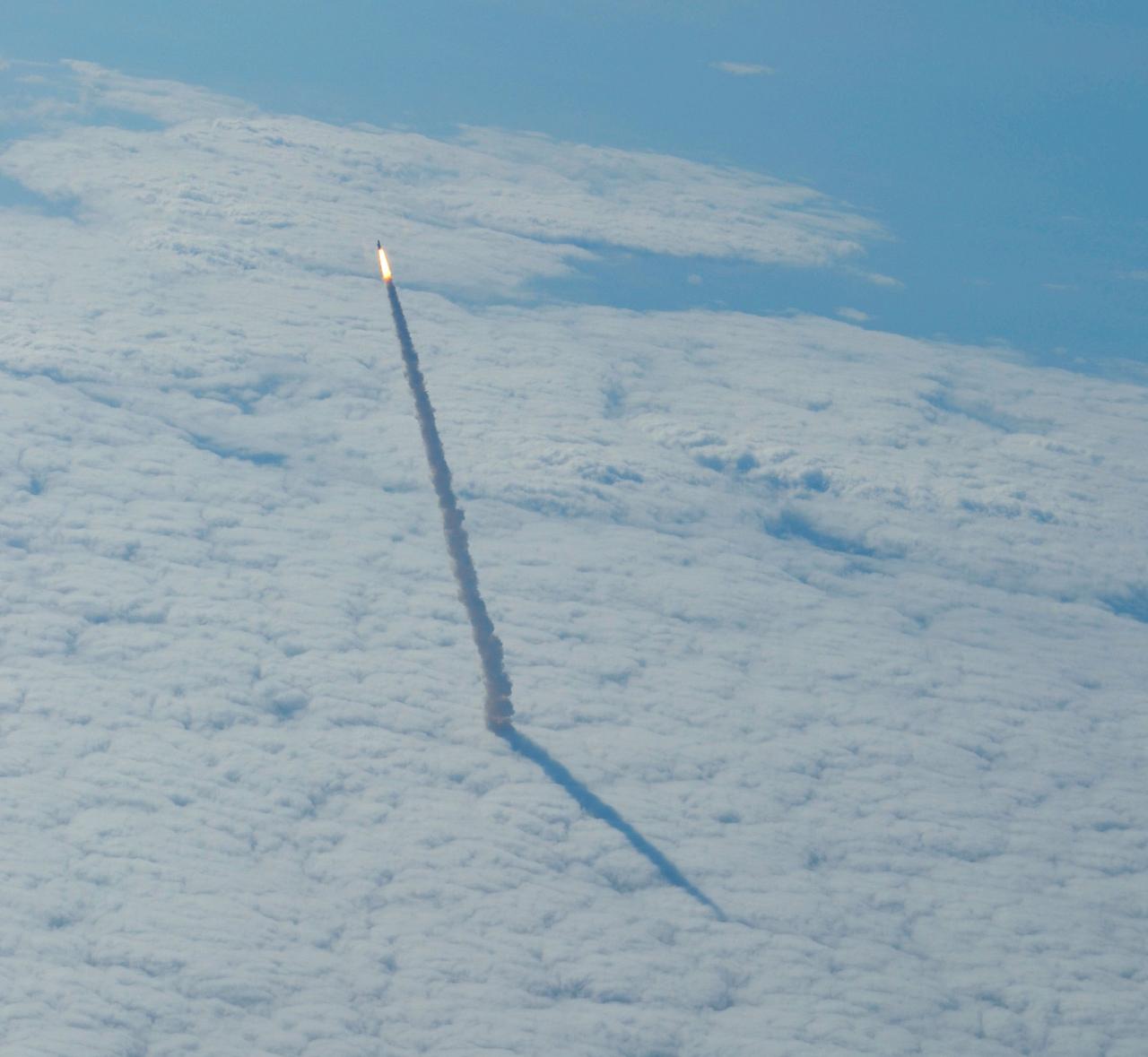 STS134-S-061 (16 May 2011) --- Photographed from a shuttle training aircraft, space shuttle Endeavour and its six-member STS-134 crew head toward Earth orbit and rendezvous with the International Space Station. Liftoff was at 8:56 a.m. (EDT) on May 16, 2011, from Launch Pad 39A at NASA's Kennedy Space Center. Onboard are NASA astronauts Mark Kelly, commander; Greg H. Johnson, pilot; Michael Fincke, Andrew Feustel, Greg Chamitoff and European Space Agency astronaut Roberto Vittori, all mission specialists. STS-134 will deliver the Alpha Magnetic Spectrometer-2 (AMS), Express Logistics Carrier-3, a high-pressure gas tank and additional spare parts for the Dextre robotic helper to the International Space Station. STS-134 is the final spaceflight for Endeavour. Photo credit: NASA