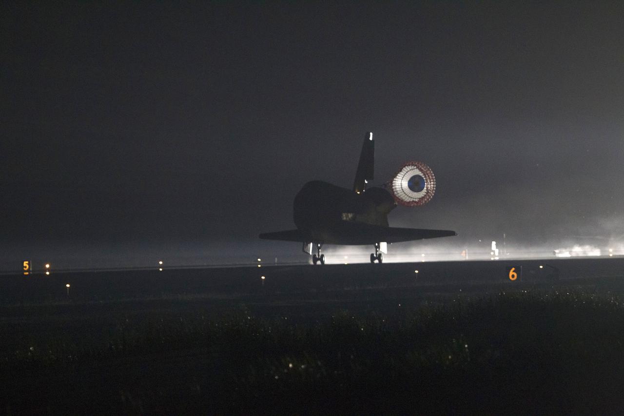 STS134-S-069 (1 June 2011) --- Xenon lights illuminate space shuttle Endeavour's unfurled drag chute as the vehicle rolls to a stop on the Shuttle Landing Facility's Runway 15 at NASA's Kennedy Space Center in Florida for the final time. Main gear touchdown was at 2:34:51 a.m. (EDT) on June 1, 2011, followed by nose gear touchdown at 2:35:04 a.m., and wheelstop at 2:35:36 a.m. Onboard are NASA astronauts Mark Kelly, STS-134 commander; Greg H. Johnson, pilot; Michael Fincke, Andrew Feustel, Greg Chamitoff and European Space Agency astronaut Roberto Vittori, all mission specialists. STS-134 delivered the Alpha Magnetic Spectrometer-2 (AMS) and the Express Logistics Carrier-3 (ELC-3) to the International Space Station. AMS will help researchers understand the origin of the universe and search for evidence of dark matter, strange matter and antimatter from the station. ELC-3 carried spare parts that will sustain station operations once the shuttles are retired from service. STS-134 was the 25th and final flight for Endeavour, which has spent 299 days in space, orbited Earth 4,671 times and traveled 122,883,151 miles. Photo credit: NASA