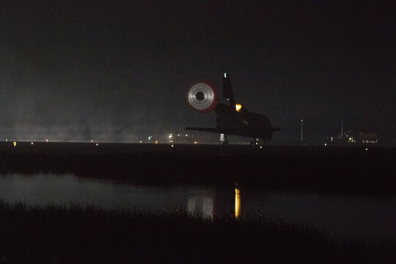 STS134-S-073 (1 June 2011) --- Xenon lights illuminate space shuttle Endeavour's unfurled drag chute as the vehicle rolls to a stop on the Shuttle Landing Facility's Runway 15 at NASA's Kennedy Space Center in Florida for the final time. Main gear touchdown was at 2:34:51 a.m. (EDT) on June 1, 2011, followed by nose gear touchdown at 2:35:04 a.m., and wheelstop at 2:35:36 a.m. Onboard are NASA astronauts Mark Kelly, STS-134 commander; Greg H. Johnson, pilot; Michael Fincke, Andrew Feustel, Greg Chamitoff and European Space Agency astronaut Roberto Vittori, all mission specialists. STS-134 delivered the Alpha Magnetic Spectrometer-2 (AMS) and the Express Logistics Carrier-3 (ELC-3) to the International Space Station. AMS will help researchers understand the origin of the universe and search for evidence of dark matter, strange matter and antimatter from the station. ELC-3 carried spare parts that will sustain station operations once the shuttles are retired from service. STS-134 was the 25th and final flight for Endeavour, which has spent 299 days in space, orbited Earth 4,671 times and traveled 122,883,151 miles. Photo credit: NASA