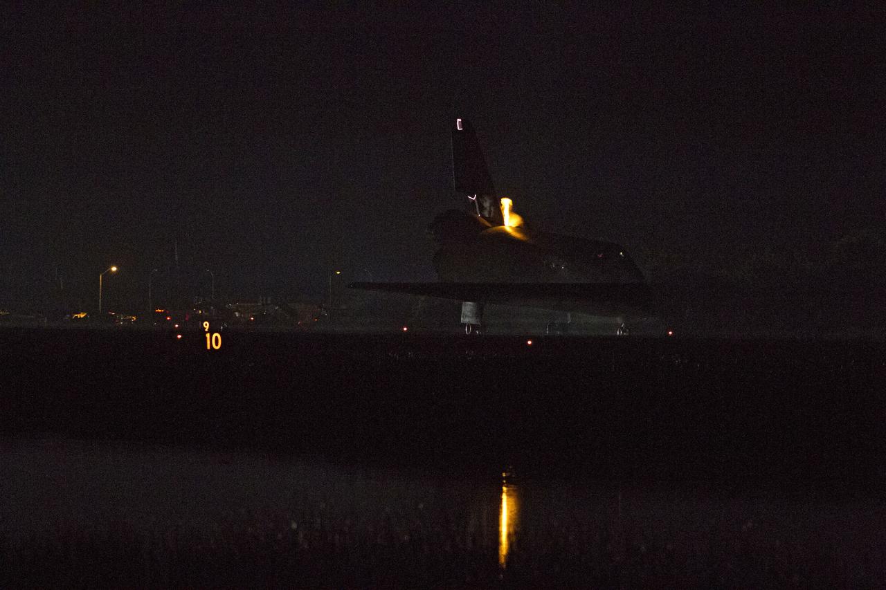 STS134-S-075 (1 June 2011) --- Heat from space shuttle Endeavour's auxiliary power units, which provide hydraulic control, can be seen at the back of the shuttle, near the vertical tail. Endeavour landed for the final time on the Shuttle Landing Facility's Runway 15 at NASA's Kennedy Space Center in Florida, marking the 24th night landing of the Space Shuttle Program. Main gear touchdown was at 2:34:51 a.m. (EDT) on June 1, 2011, followed by nose gear touchdown at 2:35:04 a.m., and wheelstop at 2:35:36 a.m. Onboard are NASA astronauts Mark Kelly, STS-134 commander; Greg H. Johnson, pilot; Michael Fincke, Andrew Feustel, Greg Chamitoff and European Space Agency astronaut Roberto Vittori, all mission specialists. STS-134 delivered the Alpha Magnetic Spectrometer-2 (AMS) and the Express Logistics Carrier-3 (ELC-3) to the International Space Station. AMS will help researchers understand the origin of the universe and search for evidence of dark matter, strange matter and antimatter from the station. ELC-3 carried spare parts that will sustain station operations once the shuttles are retired from service. STS-134 was the 25th and final flight for Endeavour, which has spent 299 days in space, orbited Earth 4,671 times and traveled 122,883,151 miles. Photo credit: NASA