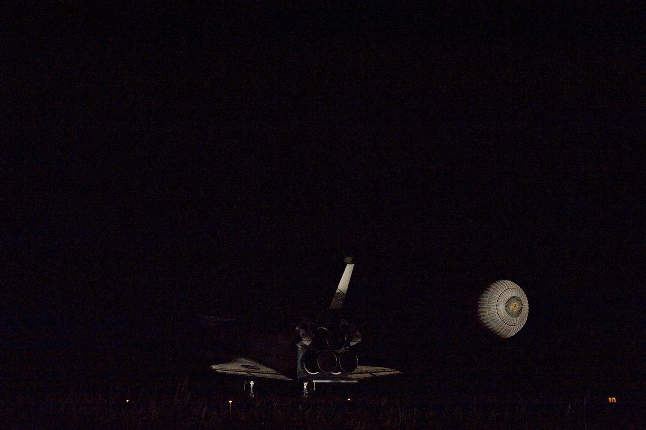 STS134-S-082 (1 June 2011) --- Xenon lights illuminate space shuttle Endeavour's unfurled drag chute as the vehicle rolls to a stop on the Shuttle Landing Facility's Runway 15 at NASA's Kennedy Space Center in Florida for the final time. Main gear touchdown was at 2:34:51 a.m. (EDT) on June 1, 2011, followed by nose gear touchdown at 2:35:04 a.m., and wheelstop at 2:35:36 a.m. Onboard are NASA astronauts Mark Kelly, STS-134 commander; Greg H. Johnson, pilot; Michael Fincke, Andrew Feustel, Greg Chamitoff and European Space Agency astronaut Roberto Vittori, all mission specialists. STS-134 delivered the Alpha Magnetic Spectrometer-2 (AMS) and the Express Logistics Carrier-3 (ELC-3) to the International Space Station. AMS will help researchers understand the origin of the universe and search for evidence of dark matter, strange matter and antimatter from the station. ELC-3 carried spare parts that will sustain station operations once the shuttles are retired from service. STS-134 was the 25th and final flight for Endeavour, which has spent 299 days in space, orbited Earth 4,671 times and traveled 122,883,151 miles. Photo credit: NASA