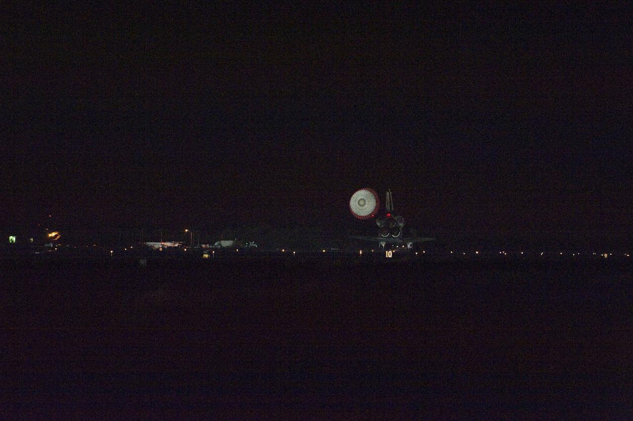 STS134-S-088 (1 June 2011) --- Space shuttle Endeavour rolls to a stop on the Shuttle Landing Facility's Runway 15 at NASA's Kennedy Space Center in Florida for the final time. Heat from the shuttle's auxiliary power units, which provide hydraulic control, can be seen at the back of Endeavour, near the vertical tail. Main gear touchdown was at 2:34:51 a.m. (EDT) on June 1, 2011, followed by nose gear touchdown at 2:35:04 a.m., and wheelstop at 2:35:36 a.m. Onboard are NASA astronauts Mark Kelly, STS-134 commander; Greg H. Johnson, pilot; Michael Fincke, Andrew Feustel, Greg Chamitoff and European Space Agency astronaut Roberto Vittori, all mission specialists. STS-134 delivered the Alpha Magnetic Spectrometer-2 (AMS) and the Express Logistics Carrier-3 (ELC-3) to the International Space Station. AMS will help researchers understand the origin of the universe and search for evidence of dark matter, strange matter and antimatter from the station. ELC-3 carried spare parts that will sustain station operations once the shuttles are retired from service. STS-134 was the 25th and final flight for Endeavour, which has spent 299 days in space, orbited Earth 4,671 times and traveled 122,883,151 miles. Photo credit: NASA