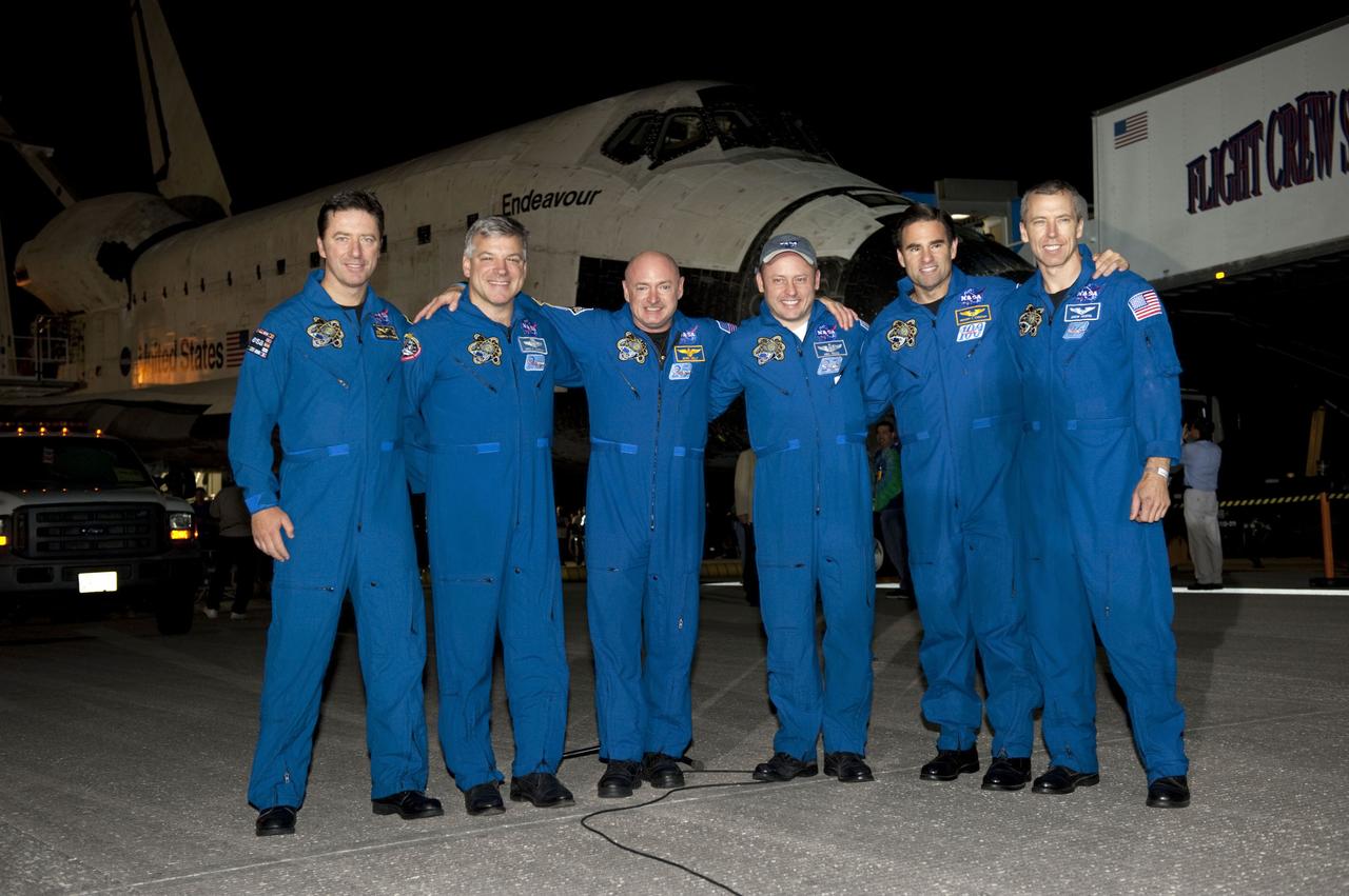 STS134-S-108 (1 June 2011) --- The crew of STS-134 pose for a photo on the Shuttle Landing Facility at NASA's Kennedy Space Center in Florida following the successful landing of space shuttle Endeavour. From left, are European Space Agency astronaut Roberto Vittori, mission specialist; NASA astronauts Greg H. Johnson, pilot; Mark Kelly, commander; Michael Fincke, Greg Chamitoff and Andrew Feustel, all mission specialists. The crew returned to Earth at 2:35 a.m. (EDT) June 1, 2011 on Runway 15, completing a 16-day, 6.5-million mile journey to the International Space Station. STS-134 delivered the Alpha Magnetic Spectrometer-2 (AMS) and the Express Logistics Carrier-3 (ELC-3) to the space station. AMS will help researchers understand the origin of the universe and search for evidence of dark matter, strange matter and antimatter from the station. ELC-3 carried spare parts that will sustain station operations once the shuttles are retired from service. STS-134 was the 25th and final flight for Endeavour, which spent 299 days in space, orbited Earth 4,671 times and traveled 122,883,151 miles. Photo credit: NASA