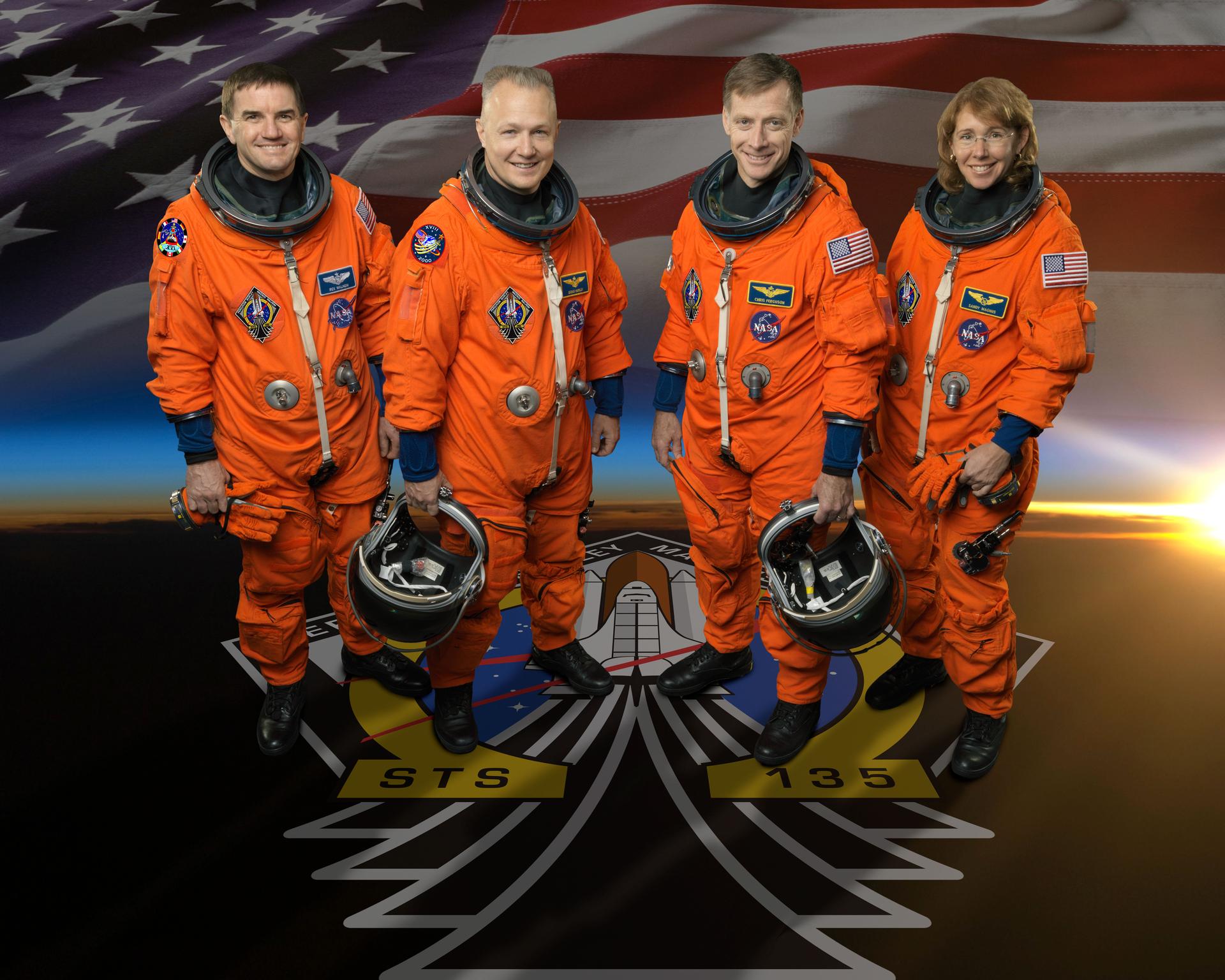 Four astronauts from STS-135 smile and wear their space flight suits.