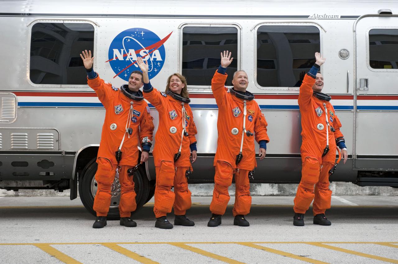 STS135-S-025 (8 July 2011) --- After suiting up, the STS-135 crew members pause alongside the Astrovan to wave farewell to onlookers before heading for launch pad 39A for the launch of space shuttle Atlantis on the STS-135 mission. From the right are NASA astronauts Chris Ferguson, commander; Doug Hurley, pilot; Sandy Magnus and Rex Walheim, both mission specialists. Atlantis is scheduled to lift off at 11:26 a.m. (EDT) on July 8 for its mission to the International Space Station. STS-135 will deliver the Raffaello multi-purpose logistics module packed with supplies and spare parts for the orbiting outpost. Atlantis also will fly the Robotic Refueling Mission experiment that will investigate the potential for robotically refueling existing satellites in orbit. In addition, Atlantis will return with a failed ammonia pump module to help NASA better understand the failure mechanism and improve pump designs for future systems. STS-135 will be the 33rd flight of Atlantis, the 37th shuttle mission to the space station, and the 135th and final mission of NASA's Space Shuttle Program. Photo credit: NASA