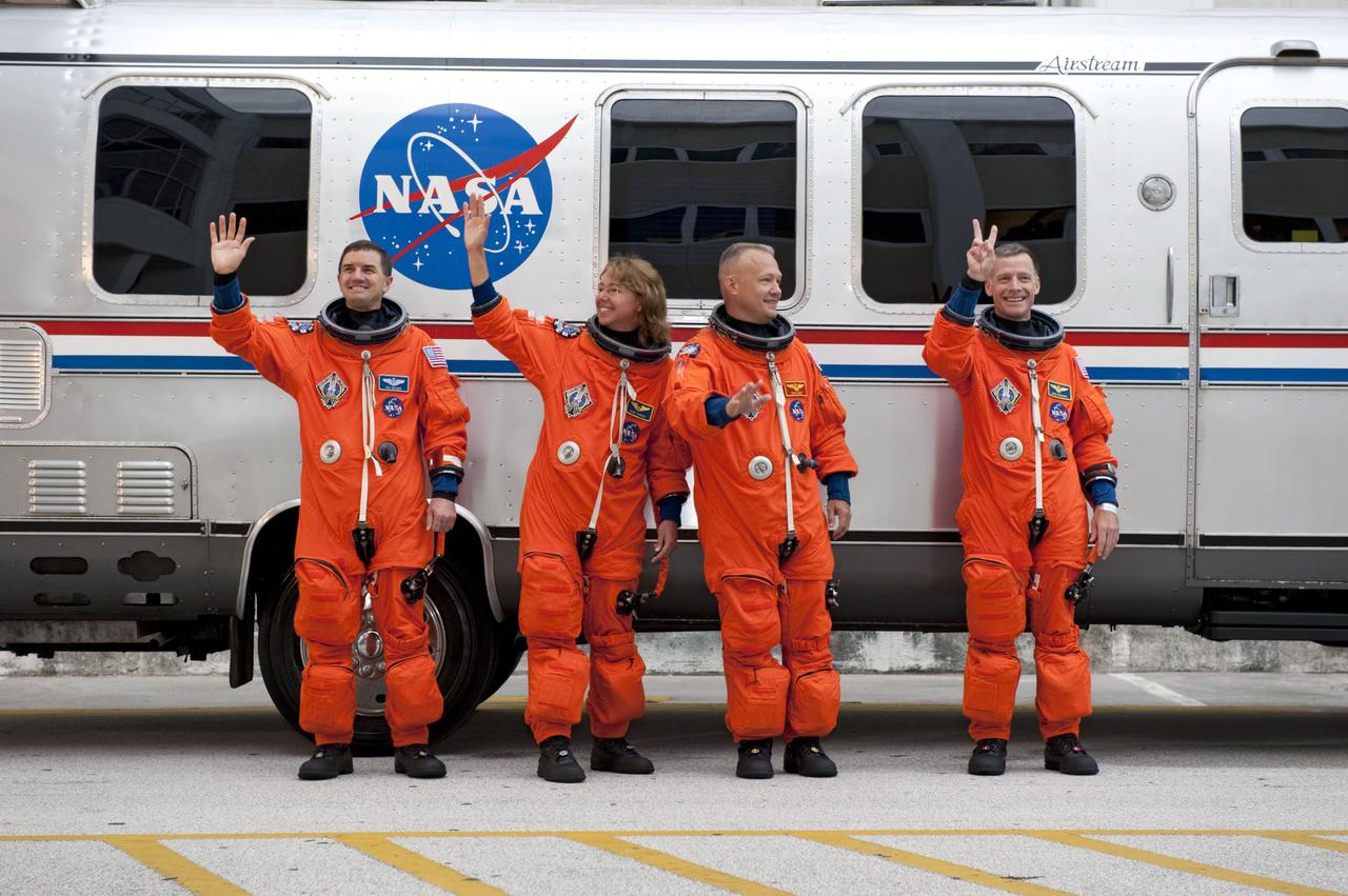 STS135-S-026 (8 July 2011) --- After suiting up, the STS-135 crew members pause alongside the Astrovan to wave farewell to onlookers before heading for launch pad 39A for the launch of space shuttle Atlantis on the STS-135 mission. From the right are NASA astronauts Chris Ferguson, commander; Doug Hurley, pilot; Sandy Magnus and Rex Walheim, both mission specialists. Atlantis is scheduled to lift off at 11:26 a.m. (EDT) on July 8 for its mission to the International Space Station. STS-135 will deliver the Raffaello multi-purpose logistics module packed with supplies and spare parts for the orbiting outpost. Atlantis also will fly the Robotic Refueling Mission experiment that will investigate the potential for robotically refueling existing satellites in orbit. In addition, Atlantis will return with a failed ammonia pump module to help NASA better understand the failure mechanism and improve pump designs for future systems. STS-135 will be the 33rd flight of Atlantis, the 37th shuttle mission to the space station, and the 135th and final mission of NASA's Space Shuttle Program. Photo credit: NASA
