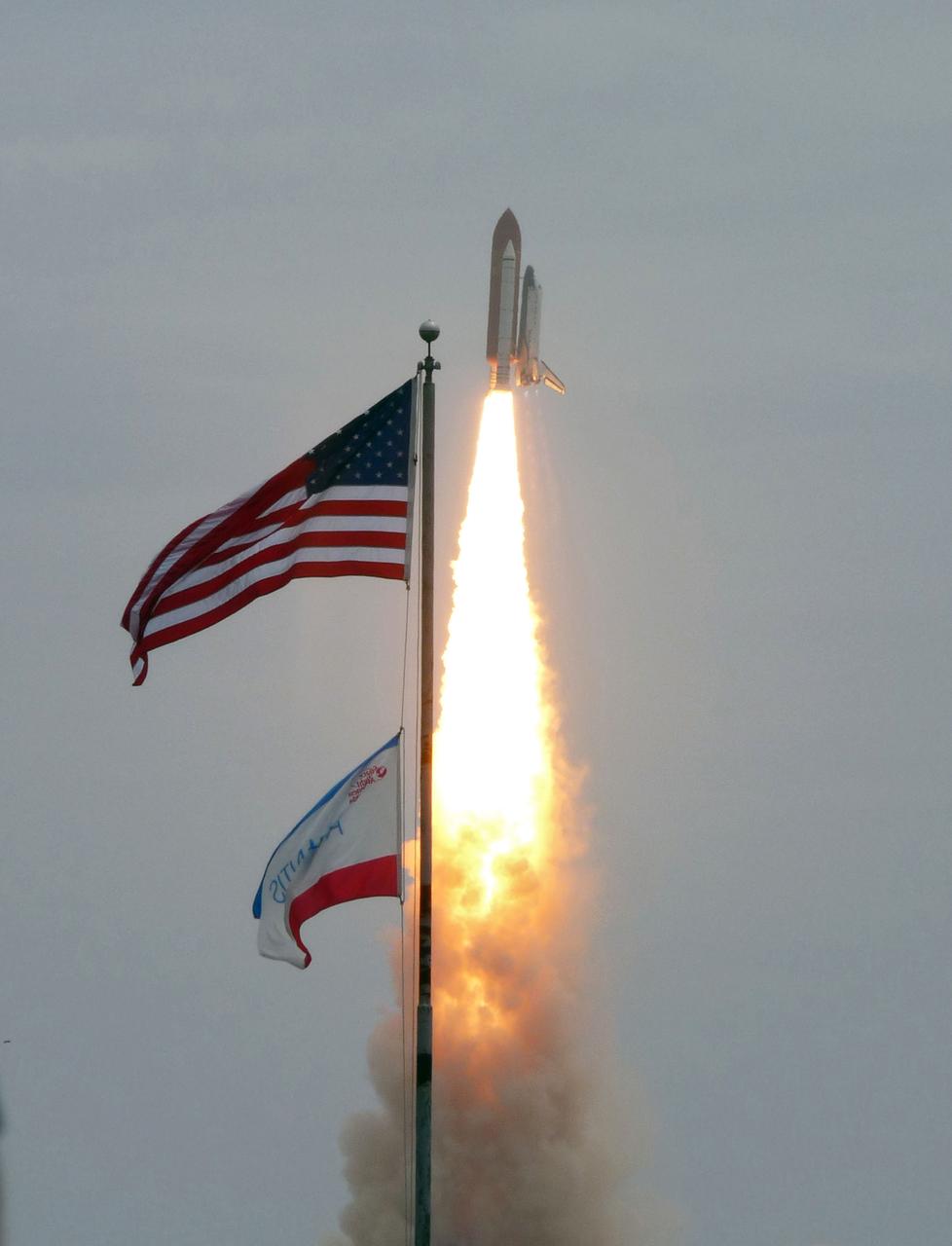 STS135-S-027 (8 July 2011) --- Space shuttle Atlantis soars past the American flag after lifting off Launch Pad 39A at NASA's Kennedy Space Center in Florida at 11:29 a.m. (EDT) on July 8, 2011. Onboard are NASA astronauts Chris Ferguson, STS-135 commander; Doug Hurley, pilot; Sandy Magnus and Rex Walheim, both mission specialists. STS-135 will deliver the Raffaello multi-purpose logistics module packed with supplies and spare parts for the International Space Station. Atlantis also will fly the Robotic Refueling Mission experiment that will investigate the potential for robotically refueling existing satellites in orbit. In addition, Atlantis will return with a failed ammonia pump module to help NASA better understand the failure mechanism and improve pump designs for future systems. STS-135 will be the 33rd flight of Atlantis, the 37th shuttle mission to the space station, and the 135th and final mission of NASA's Space Shuttle Program. Photo credit: NASA