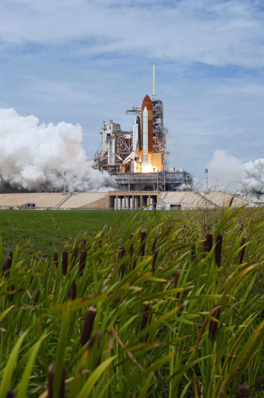 STS135-S-094 (8 July 2011) --- Space shuttle Atlantis and its four-member STS-135 crew head toward Earth orbit and rendezvous with the International Space Station. Liftoff was at 11:29 a.m. (EDT) on July 8, 2011 from Launch Pad 39A at NASA's Kennedy Space Center. Onboard are NASA astronauts Chris Ferguson, commander; Doug Hurley, pilot; Sandy Magnus and Rex Walheim, both mission specialists. STS-135 will deliver the Raffaello multi-purpose logistics module packed with supplies and spare parts for the space station. Atlantis also carries the Robotic Refueling Mission experiment that will investigate the potential for robotically refueling existing satellites in orbit. In addition, Atlantis will return with a failed ammonia pump module to help NASA better understand the failure mechanism and improve pump designs for future systems. STS-135 will be the 33rd flight of Atlantis, the 37th shuttle mission to the space station, and the 135th and final mission of NASA's Space Shuttle Program. Photo credit: NASA