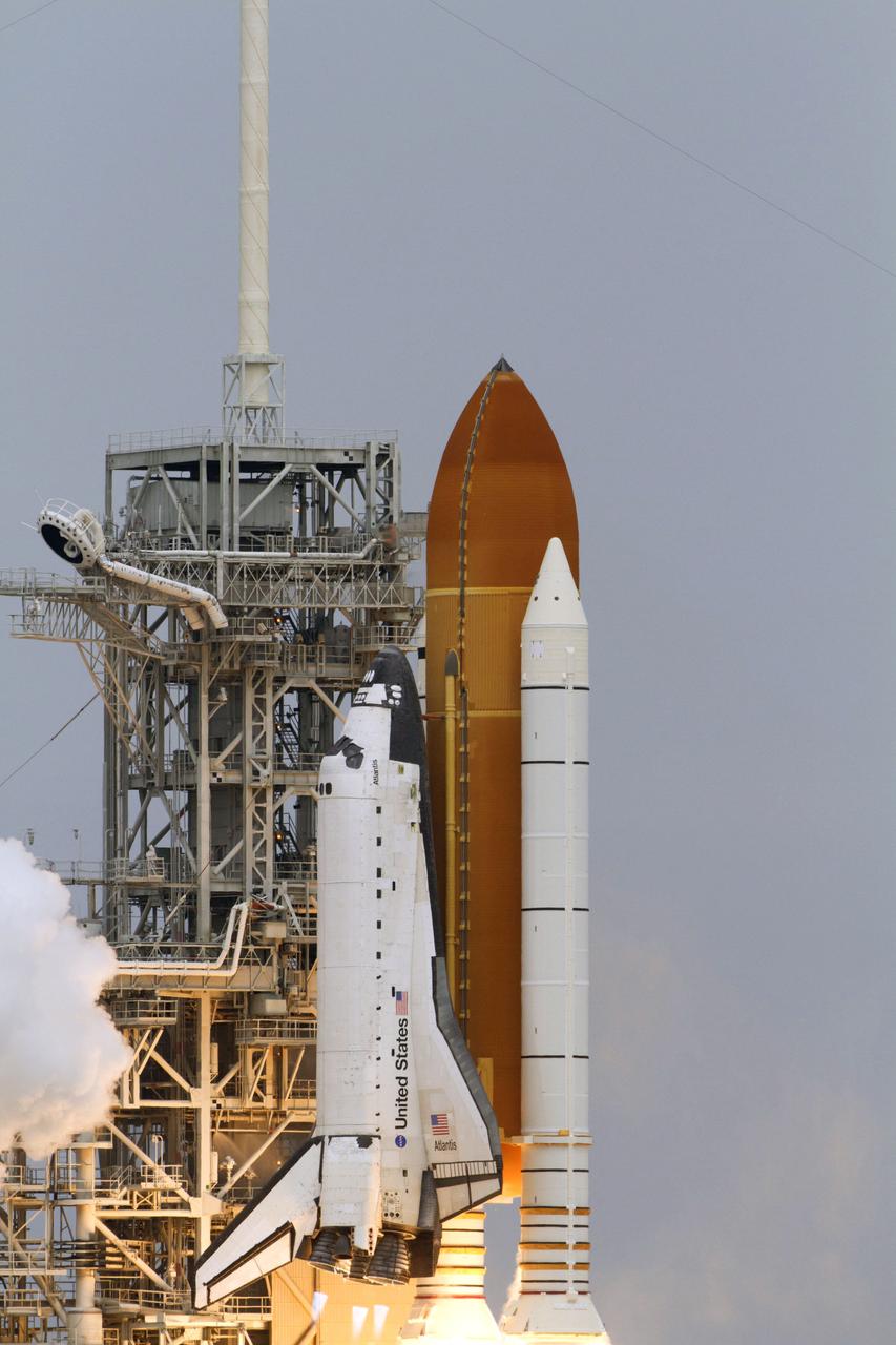STS135-S-153 (8 July 2011) --- Space shuttle Atlantis and its four-member STS-135 crew head toward Earth orbit and rendezvous with the International Space Station. Liftoff was at 11:29 a.m. (EDT) on July 8, 2011 from Launch Pad 39A at NASA's Kennedy Space Center. Onboard are NASA astronauts Chris Ferguson, commander; Doug Hurley, pilot; Sandy Magnus and Rex Walheim, both mission specialists. STS-135 will deliver the Raffaello multi-purpose logistics module packed with supplies and spare parts for the space station. Atlantis also carries the Robotic Refueling Mission experiment that will investigate the potential for robotically refueling existing satellites in orbit. In addition, Atlantis will return with a failed ammonia pump module to help NASA better understand the failure mechanism and improve pump designs for future systems. STS-135 will be the 33rd flight of Atlantis, the 37th shuttle mission to the space station, and the 135th and final mission of NASA's Space Shuttle Program. Photo credit: NASA