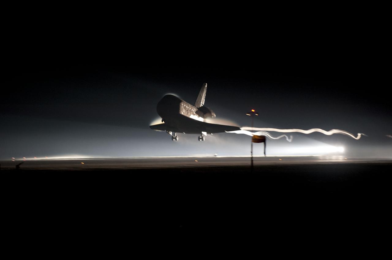 STS135-S-157 (21 July 2011) --- Ribbons of steam and smoke trail space shuttle Atlantis as it nears touchdown on the Shuttle Landing Facility's Runway 15 at NASA's Kennedy Space Center in Florida for the final time. Securing the space shuttle fleet's place in history, Atlantis marked the 26th nighttime landing of NASA's Space Shuttle Program and the 78th landing at Kennedy. Main gear touchdown was at 5:57:00 a.m. (EDT) on July 21, 2011, followed by nose gear touchdown at 5:57:20 a.m., and wheelstop at 5:57:54 a.m. Onboard are NASA astronauts Chris Ferguson, STS-135 commander; Doug Hurley, pilot; Sandy Magnus and Rex Walheim, both mission specialists. On the 37th shuttle mission to the International Space Station, STS-135 delivered more than 9,400 pounds of spare parts, equipment and supplies in the Raffaello multi-purpose logistics module that will sustain station operations for the next year. STS-135 was the 33rd and final flight for Atlantis, which has spent 307 days in space, orbited Earth 4,848 times and traveled 125,935,769 miles. Photo credit: NASA