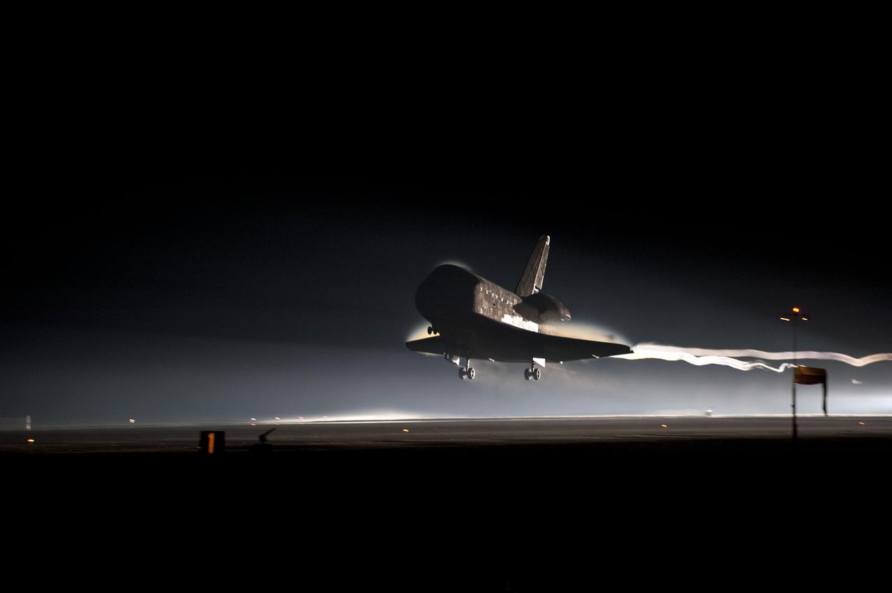 STS135-S-158 (21 July 2011) --- Ribbons of steam and smoke trail space shuttle Atlantis as it nears touchdown on the Shuttle Landing Facility's Runway 15 at NASA's Kennedy Space Center in Florida for the final time. Securing the space shuttle fleet's place in history, Atlantis marked the 26th nighttime landing of NASA's Space Shuttle Program and the 78th landing at Kennedy. Main gear touchdown was at 5:57:00 a.m. (EDT) on July 21, 2011, followed by nose gear touchdown at 5:57:20 a.m., and wheelstop at 5:57:54 a.m. Onboard are NASA astronauts Chris Ferguson, STS-135 commander; Doug Hurley, pilot; Sandy Magnus and Rex Walheim, both mission specialists. On the 37th shuttle mission to the International Space Station, STS-135 delivered more than 9,400 pounds of spare parts, equipment and supplies in the Raffaello multi-purpose logistics module that will sustain station operations for the next year. STS-135 was the 33rd and final flight for Atlantis, which has spent 307 days in space, orbited Earth 4,848 times and traveled 125,935,769 miles. Photo credit: NASA