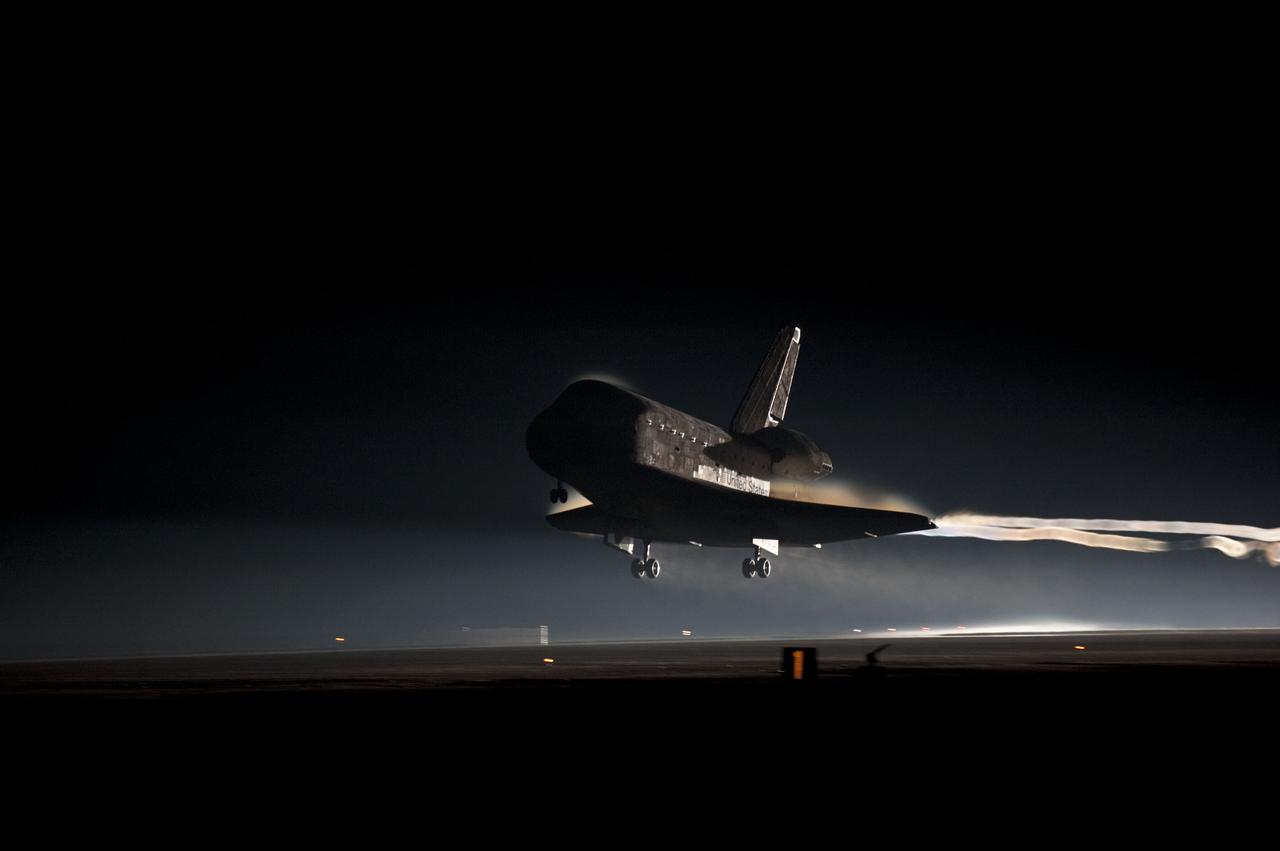 STS135-S-159 (21 July 2011) --- Ribbons of steam and smoke trail space shuttle Atlantis as it nears touchdown on the Shuttle Landing Facility's Runway 15 at NASA's Kennedy Space Center in Florida for the final time. Securing the space shuttle fleet's place in history, Atlantis marked the 26th nighttime landing of NASA's Space Shuttle Program and the 78th landing at Kennedy. Main gear touchdown was at 5:57:00 a.m. (EDT) on July 21, 2011, followed by nose gear touchdown at 5:57:20 a.m., and wheelstop at 5:57:54 a.m. Onboard are NASA astronauts Chris Ferguson, STS-135 commander; Doug Hurley, pilot; Sandy Magnus and Rex Walheim, both mission specialists. On the 37th shuttle mission to the International Space Station, STS-135 delivered more than 9,400 pounds of spare parts, equipment and supplies in the Raffaello multi-purpose logistics module that will sustain station operations for the next year. STS-135 was the 33rd and final flight for Atlantis, which has spent 307 days in space, orbited Earth 4,848 times and traveled 125,935,769 miles. Photo credit: NASA