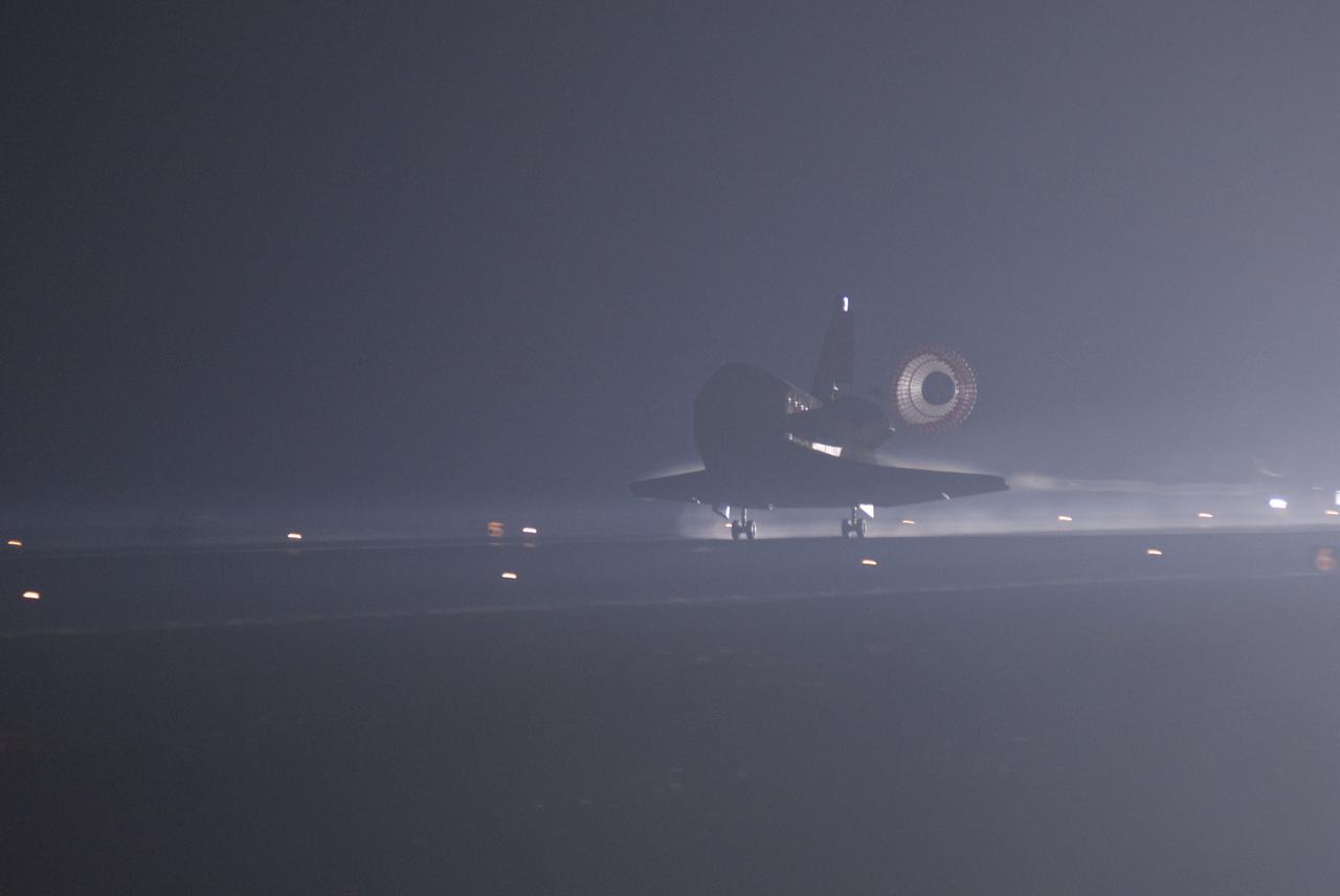 STS135-S-164 (21 July 2011) --- Xenon lights illuminate space shuttle Atlantis' unfurled drag chute as the vehicle rolls to a stop on the Shuttle Landing Facility's Runway 15 at NASA's Kennedy Space Center in Florida for the final time. Securing the space shuttle fleet's place in history, Atlantis marked the 26th nighttime landing of NASA's Space Shuttle Program and the 78th landing at Kennedy. Main gear touchdown was at 5:57:00 a.m. (EDT) on July 21, 2011, followed by nose gear touchdown at 5:57:20 a.m., and wheelstop at 5:57:54 a.m. Onboard are NASA astronauts Chris Ferguson, STS-135 commander; Doug Hurley, pilot; Sandy Magnus and Rex Walheim, both mission specialists. On the 37th shuttle mission to the International Space Station, STS-135 delivered more than 9,400 pounds of spare parts, equipment and supplies in the Raffaello multi-purpose logistics module that will sustain station operations for the next year. STS-135 was the 33rd and final flight for Atlantis, which has spent 307 days in space, orbited Earth 4,848 times and traveled 125,935,769 miles. Photo credit: NASA